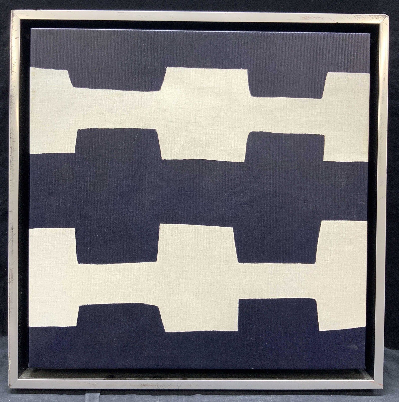Framed Minimalist Lithograph: Framed minimalist painting in navy blue and white geometric patterns in a silver toned wooden floater frame. Approximately 17.75 x 17.75 inches. Framed minimalist art, art, frames art, decorative art,