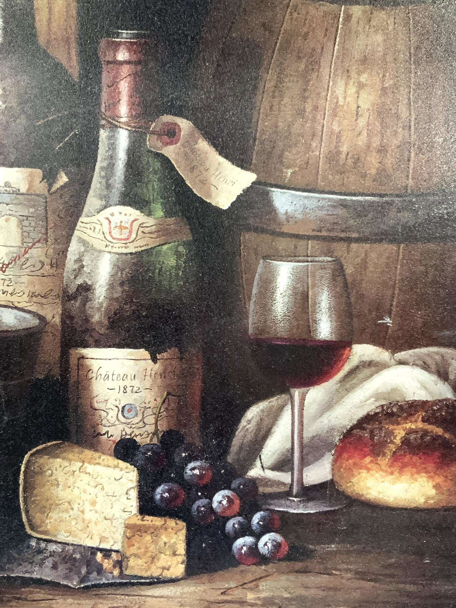 Framed Wine, Cheese & Bread Still Life Lithograph: Framed Lithograph depicting a wine bottle with a glass, and load of bread next to it, with a bunch of grapes and cheese in front of the bottle. Approximately 20 x 25 inches. Wooden frame. Framed litho