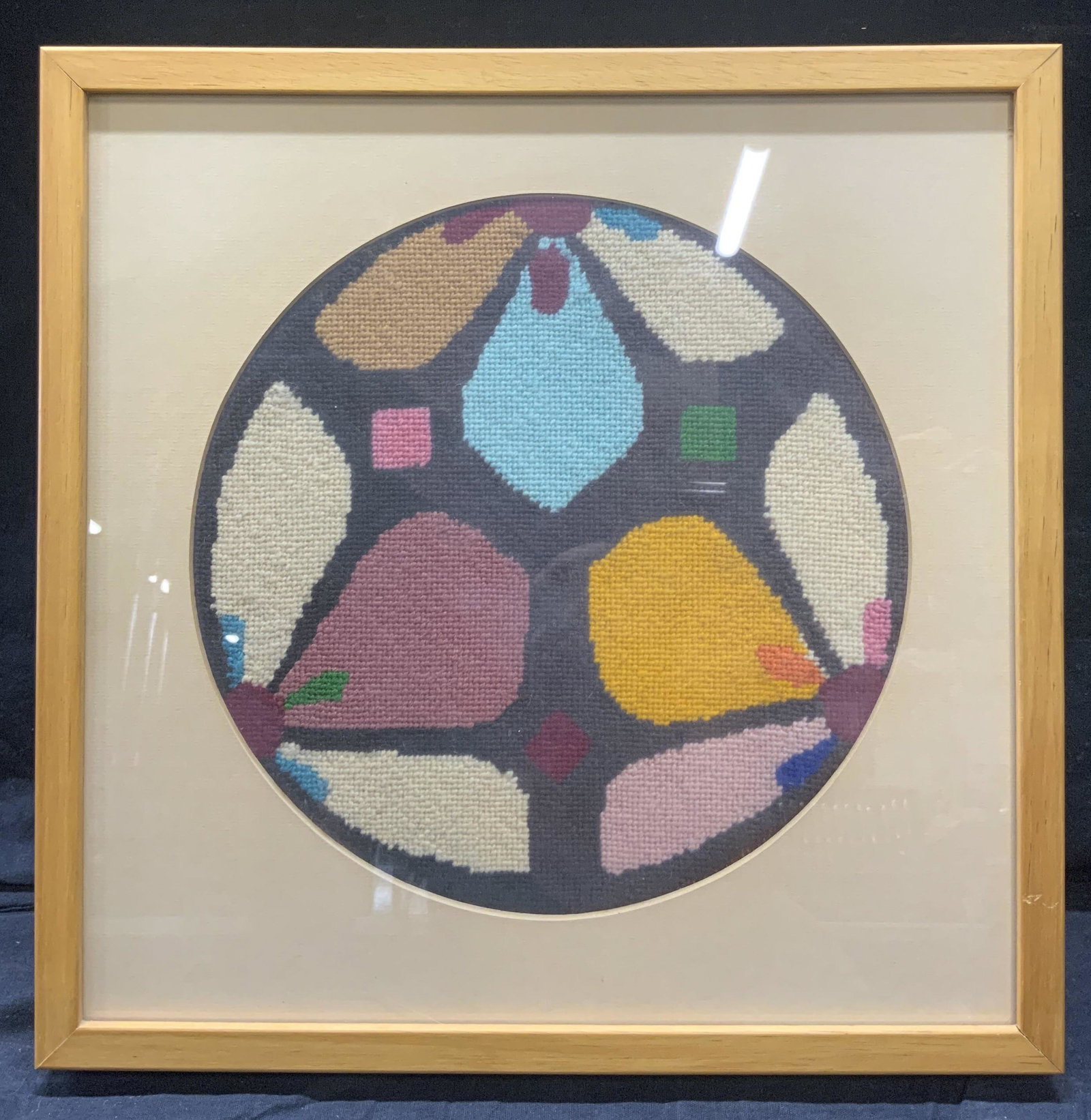 Vintage Midcentury Floral Crochet Art: Vintage Midcentury Floral Crochet Art, no apparent inscriptions, knitted subject shows colorful geometric flowers, in frame measures approx 13 x 13 in., tan wood frame, surface wear to frame, professi