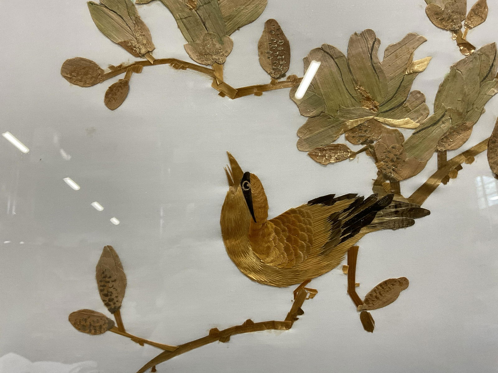 Collage Artwork of a Bird on Flowering Branch: Collage Artwork of a Bird on flowering branch, appears to be comprised of thin wood, no apparent inscriptions or signatures to piece, subject a bird resting on a tree branch, measures 12 x 14 inches,