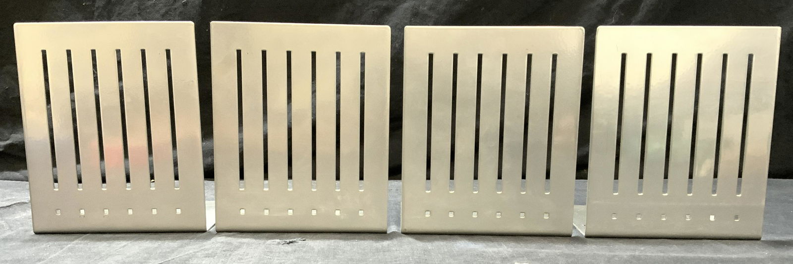 Set 4 SPECTRUM DIV DESIGNS Metal Bookends: Undersides are inscribed SPECTRUM DIV DESIGNS. Lot includes 4 bookends. Each are silver toned and metal. Pieces have pierced detail. Each measures approx 6 inches tall 5 inches wide 4.5 inches deep. B