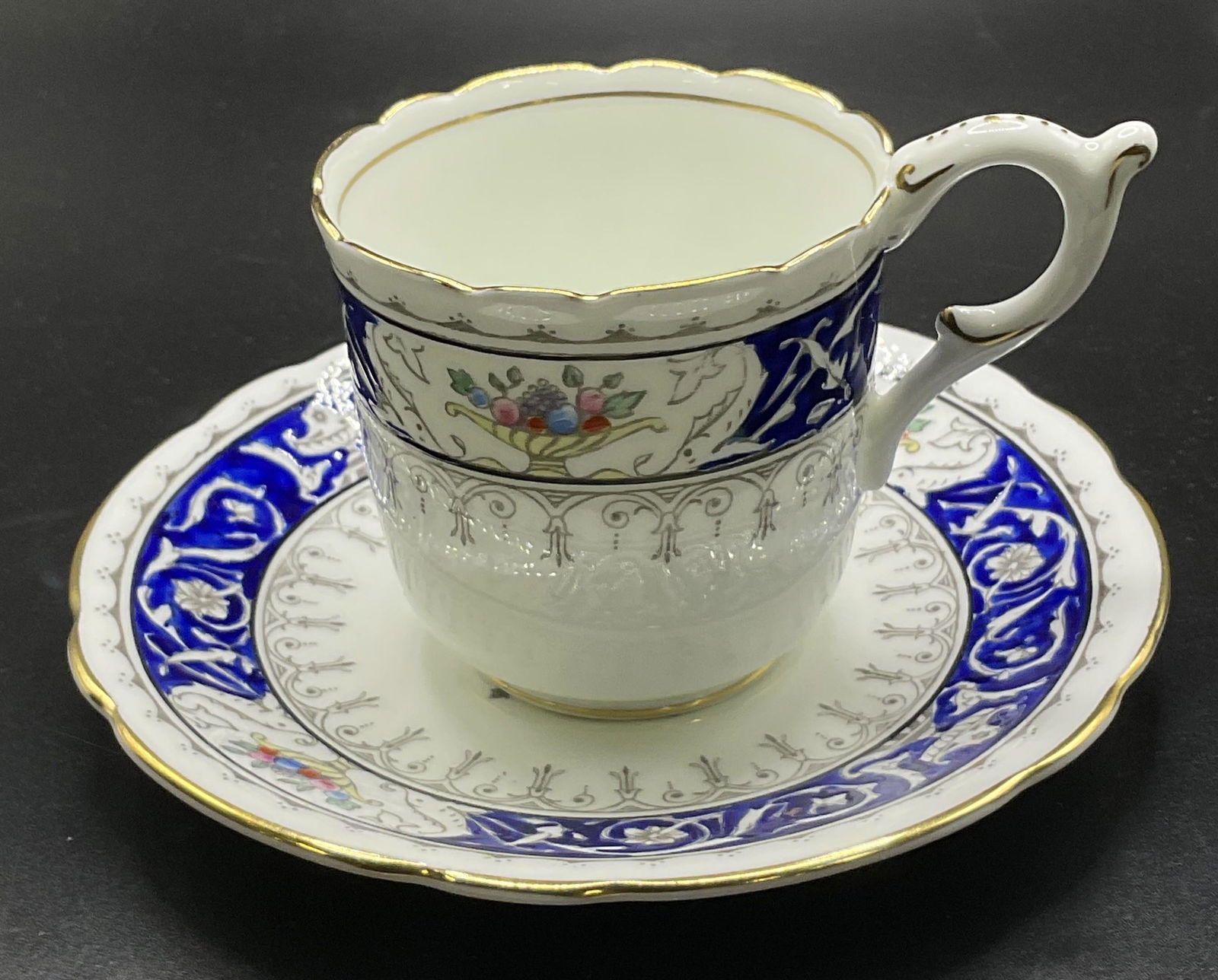 Bone China Tea Cup & Saucer, England: Bone China Teacup & saucer. Gold Tone to rim of cup and saucer. Underside reads ‘Coalport, bone China, Made in England, Montreal’. Measures approx 4.5 x 2.5 inches. Surface wear to piece consisten