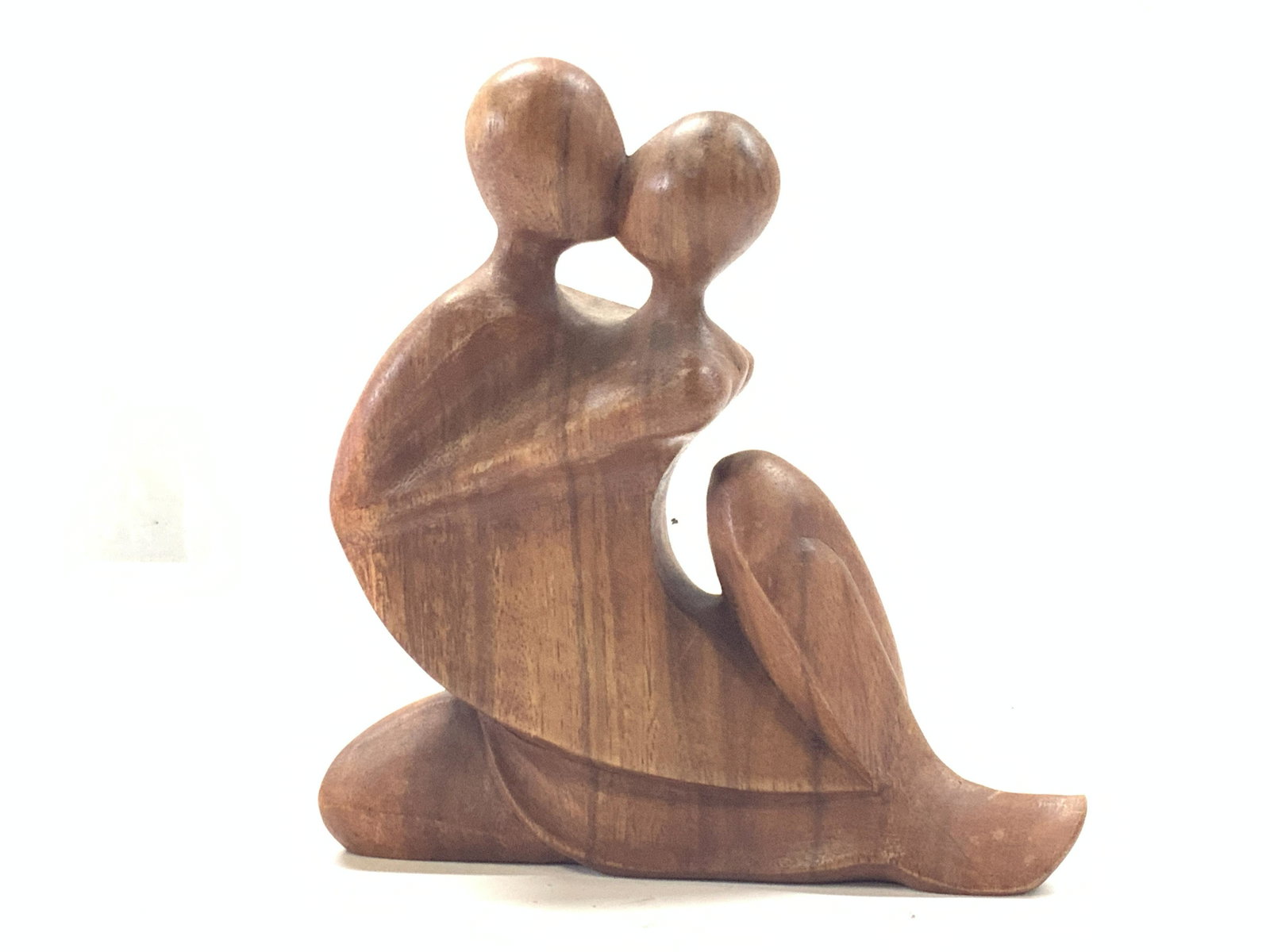 W.Rendah Signed NOVICA Abstract Wooden Figure: Signed on underside W.Rendah. Sticker on underside reads NOVICA Collection, Indonesia. Figure depicts 2 abstract figures in an embrace carved from wood. Approximately 8 inches tall and 7.5 inches long
