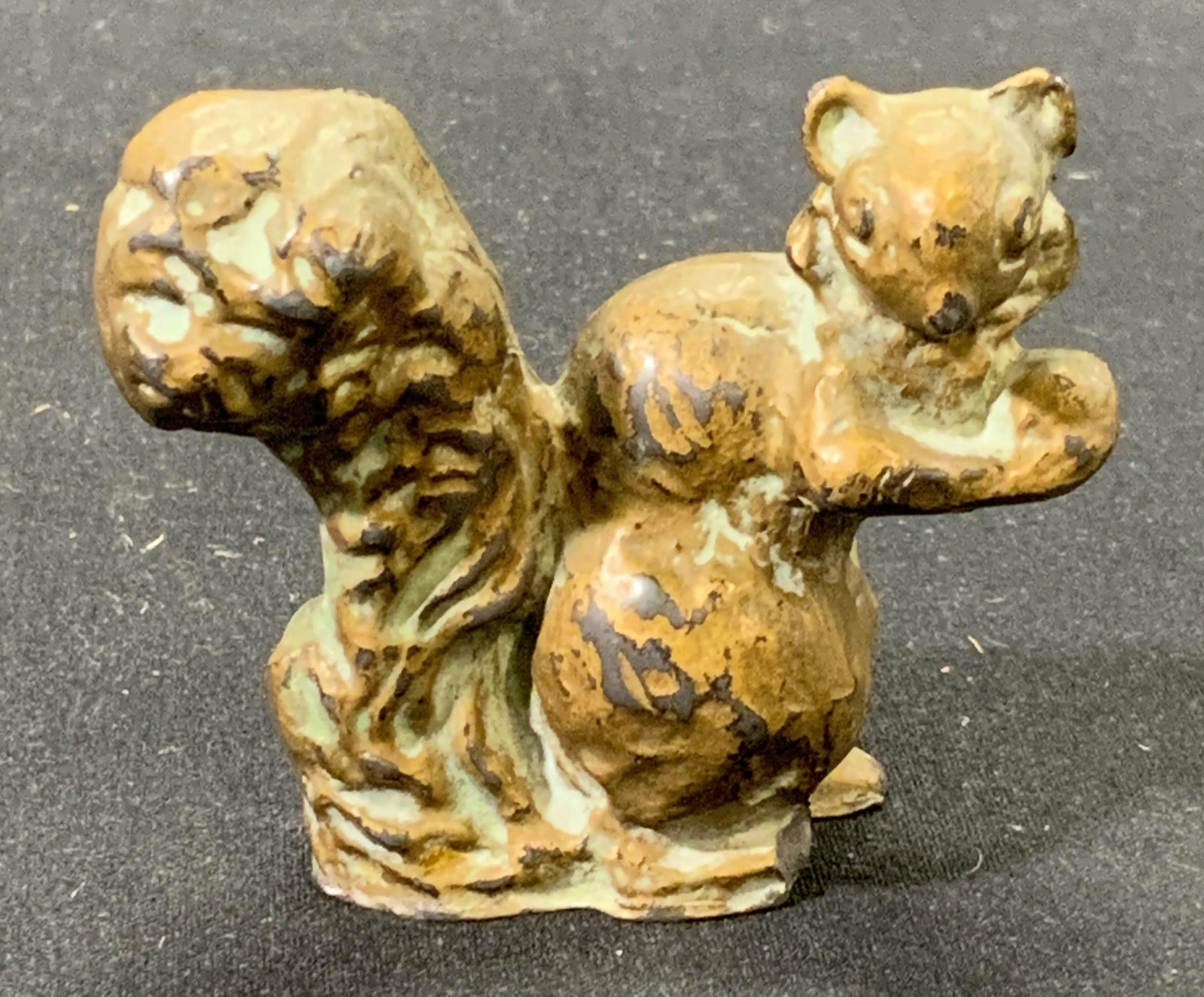 Brass Style Miniature Squirrel Figurine: A brass style finish metal squirrel figurine. Measures approx. 2 x .75 x 1.75 inches. Surface wear consistent with age and exposure. Piece has weight. Figurine, metal figurine, squirrel figurine, squi