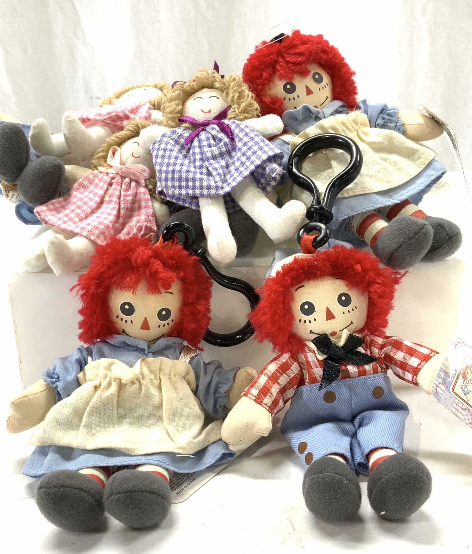 Lot 9 NWT Raggedy Ann & Andy Backpack Dolls, more: Liscences by Simon and Schuster United Media are these new Raggedy Ann and Andy ( 5.5 x 4in) bag charm dolls, keychain dolls. 5 of Raggedy Ann, 1 Raggedy Andy and 3 miniature fabric doll ornaments for