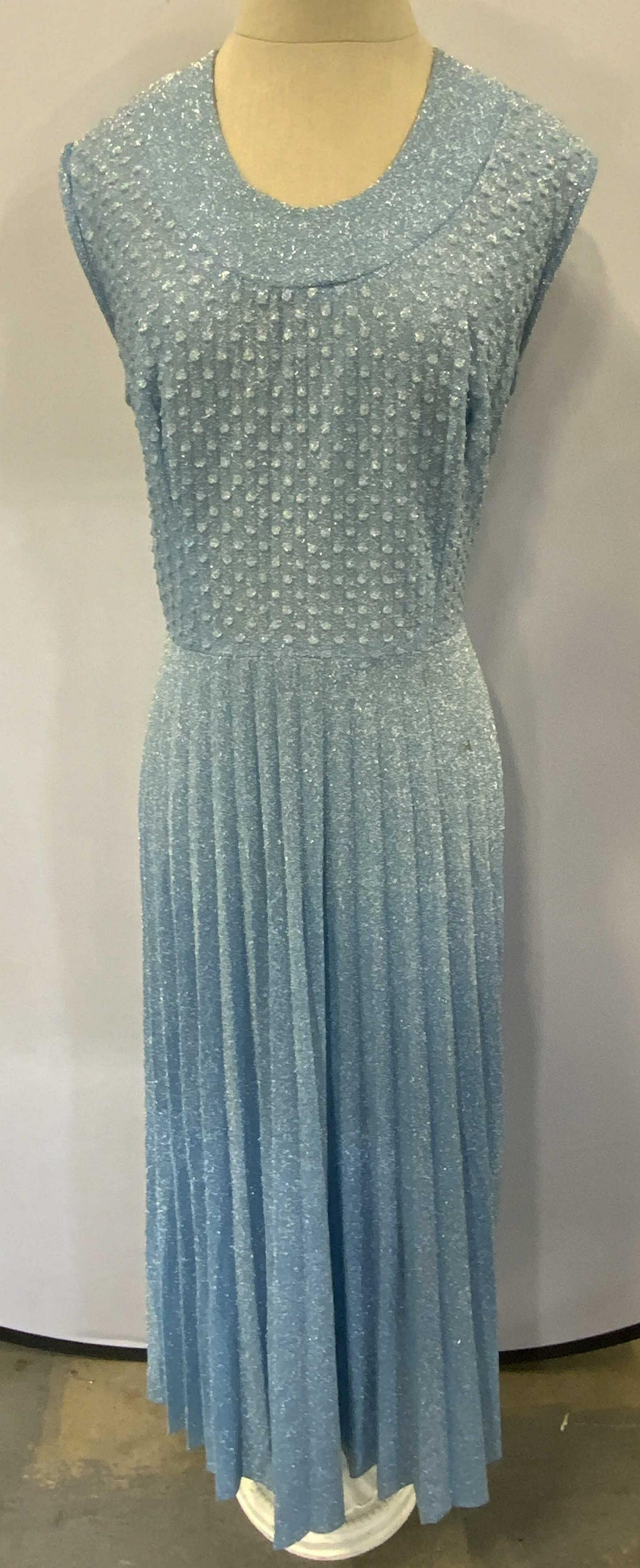Vintage Shimmery Blue Textured Maxi Dress: Vintage shimmery blue maxi dress with textured dot detail and pleated skirt. No size, measures approx. 18 inches across chest and 56 inches from shoulder to hem. Small blemish near hip. Back zipper cl
