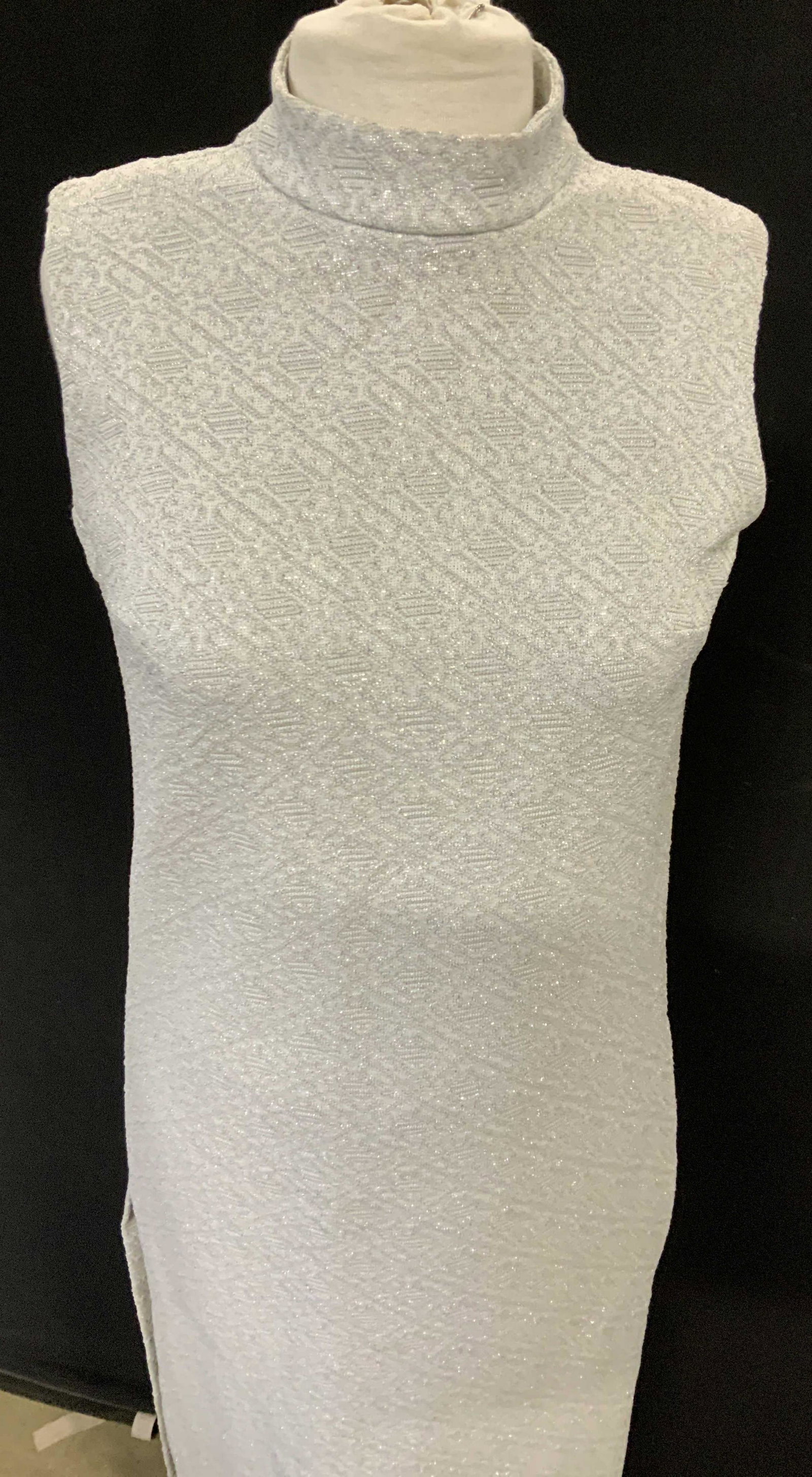 Silver Textured Fabric Cocktail Shift Dress: This dress has a textured fabric , possibly polyester, which has a bit of glitter, high collar and sleeveless, with side slits for walking, backside zipper and hook and loop neck closure. Slender neck