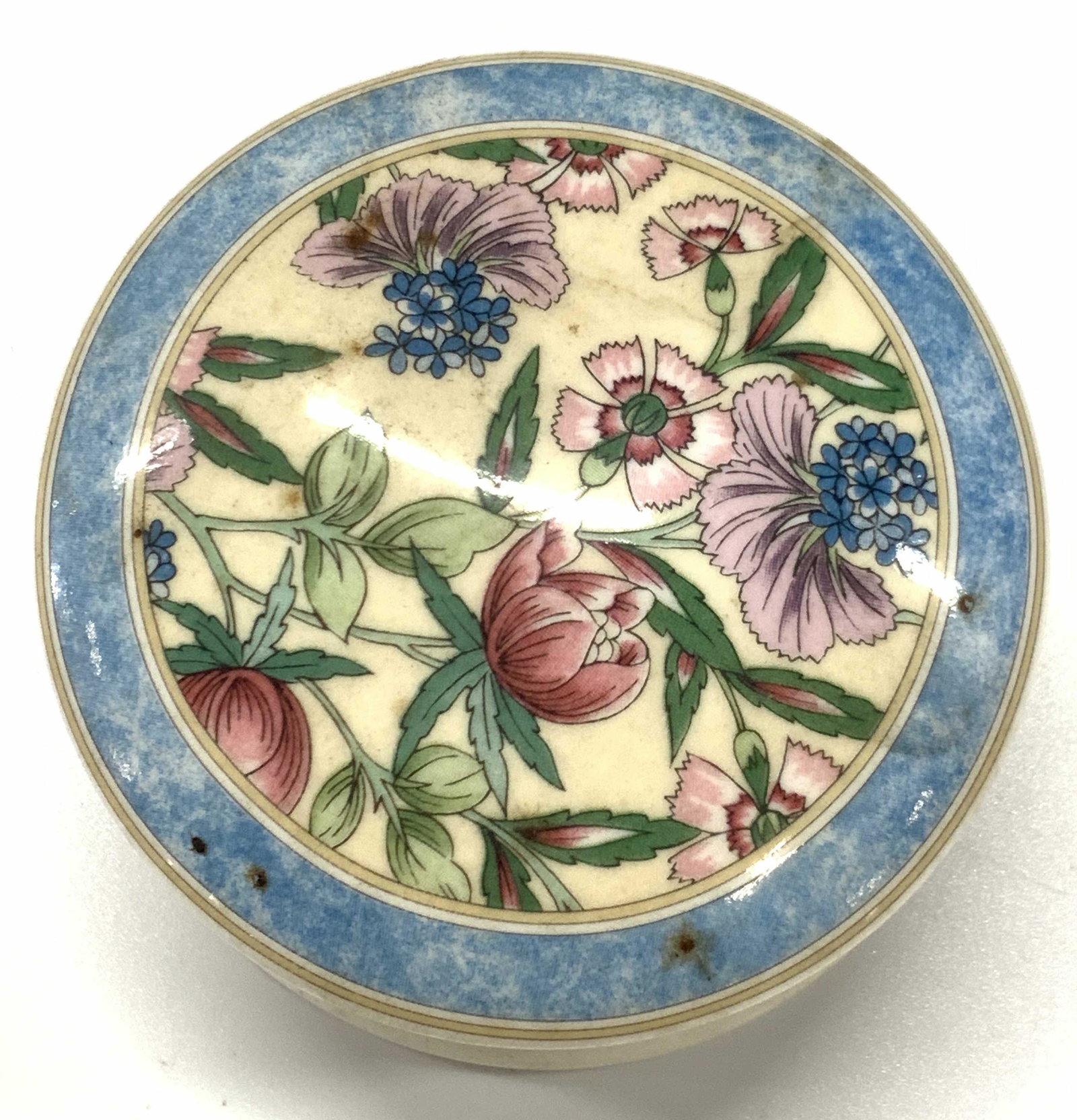 WEDGWOOD Bone China Trinket Box , England: Painted Porcelain trinket box, circular in shape with marble style blue and off white on body. Lid is painted with floral motifs in tones of pinks and reds with blue marble speckled band. Underside is