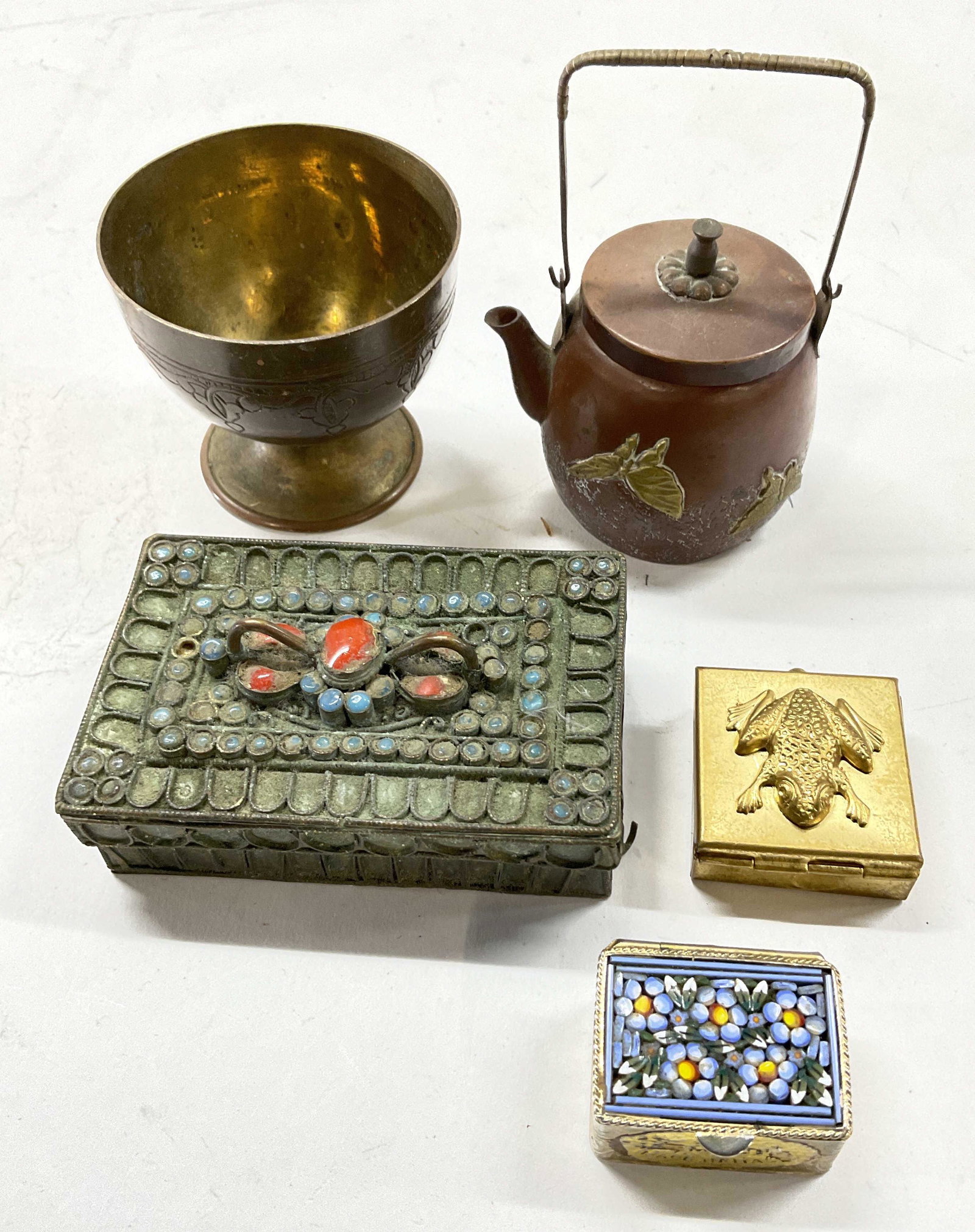 Lot Miniature Metalwares, Mosaic Pill Box & More: Lot Miniature Metalwares. Floral glass Mosaic Pill Box, Pill box with frog relief, metal box with faceted glass detail, bottomless miniature tea top with butterfly relief, brass metalware. Largest pie