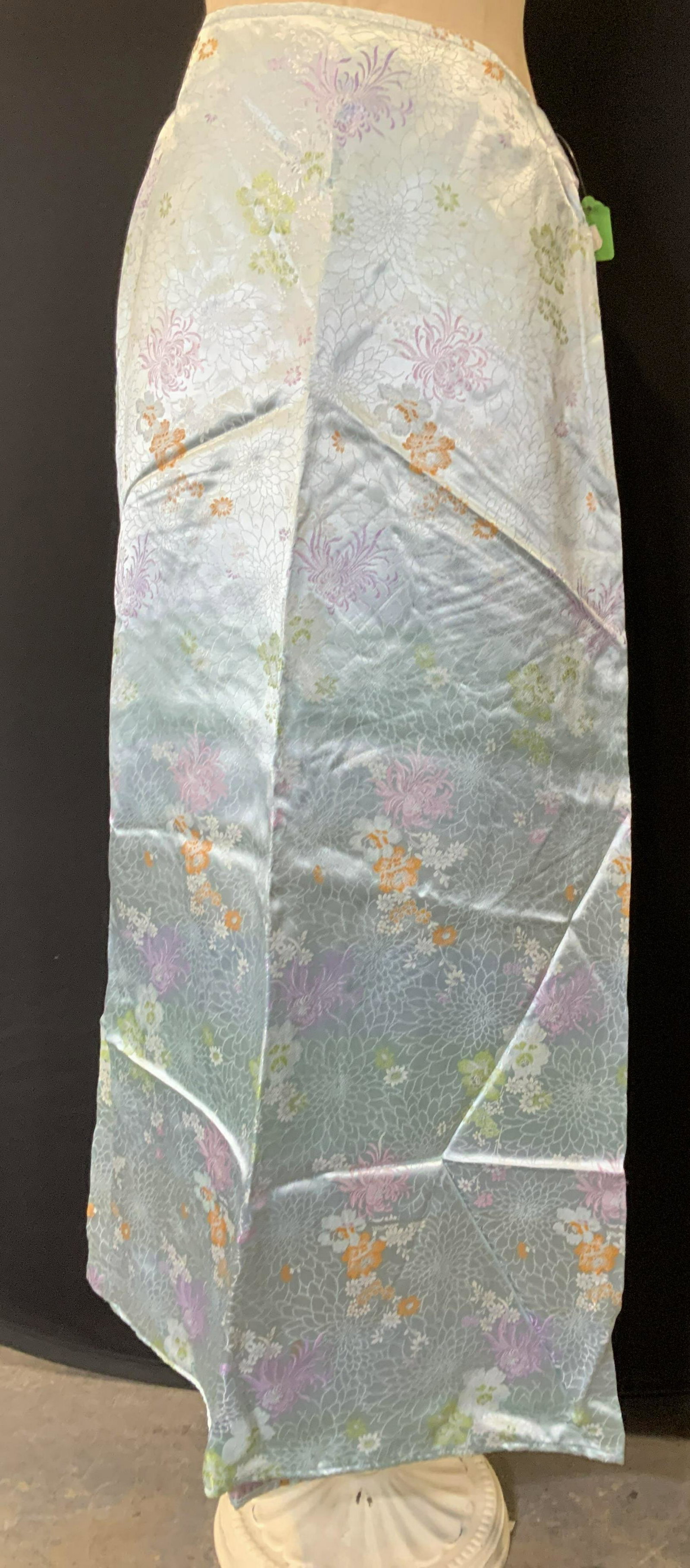 Pair GEORGETTE ASIAN FLORAL SKIRTS: Signed designer Georgette skirts, rayon, aqua blue with purple, orange, green and pinks Asian florals- spider Lily, chrysanthemum and rose. Waist 26 in. Length 39 in. These are new without tags. Asian