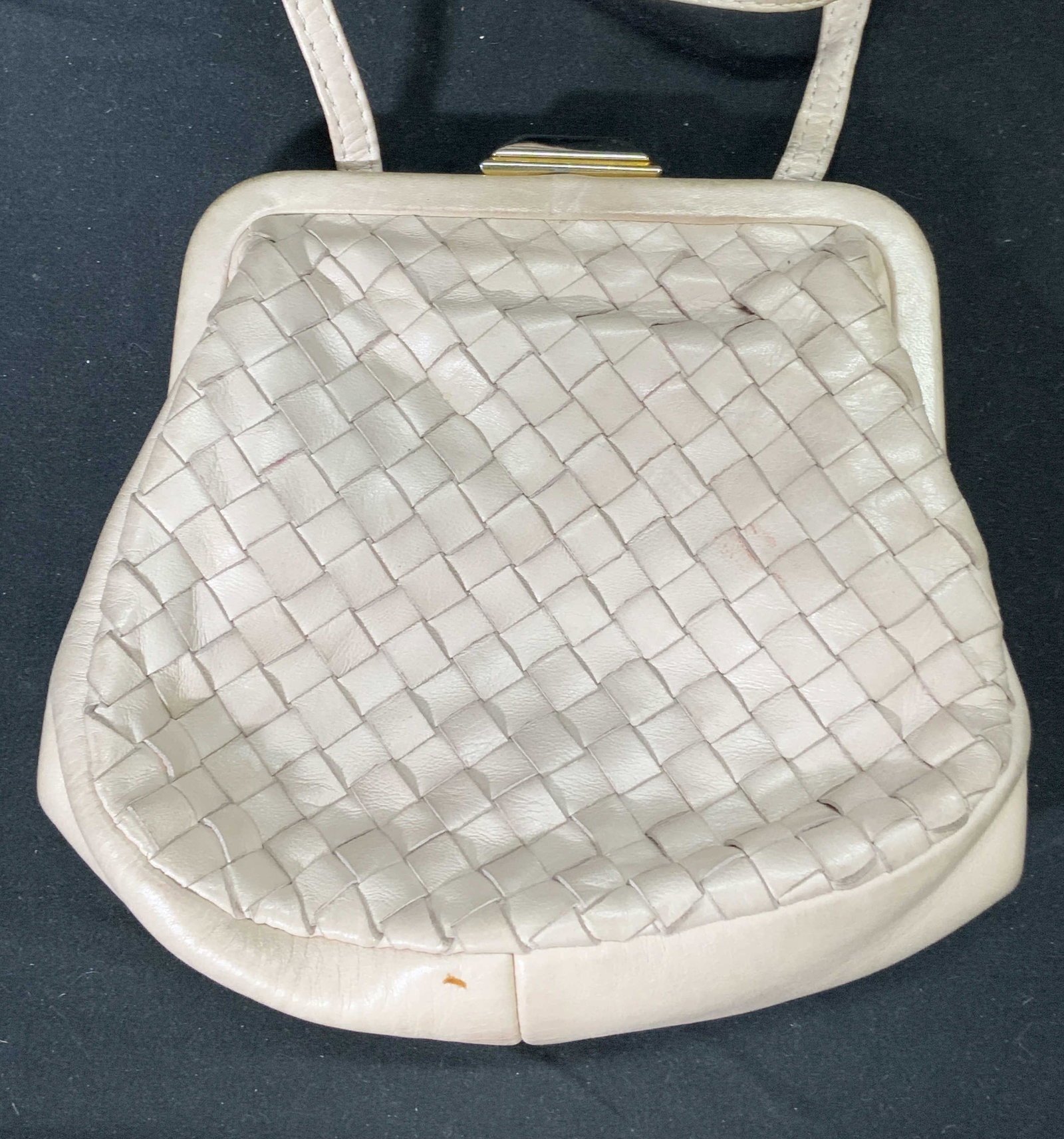 Beige Woven Leather Crossbody Bag, Italy: A woven leather crossbody handbag in beige. Push clasp closure. Some wear consistent with use and exposure. Measures approx. 6.5 x 2 x 5.5 inches. Strap drop approx. 22 inches long. Marked GENUINE LEA