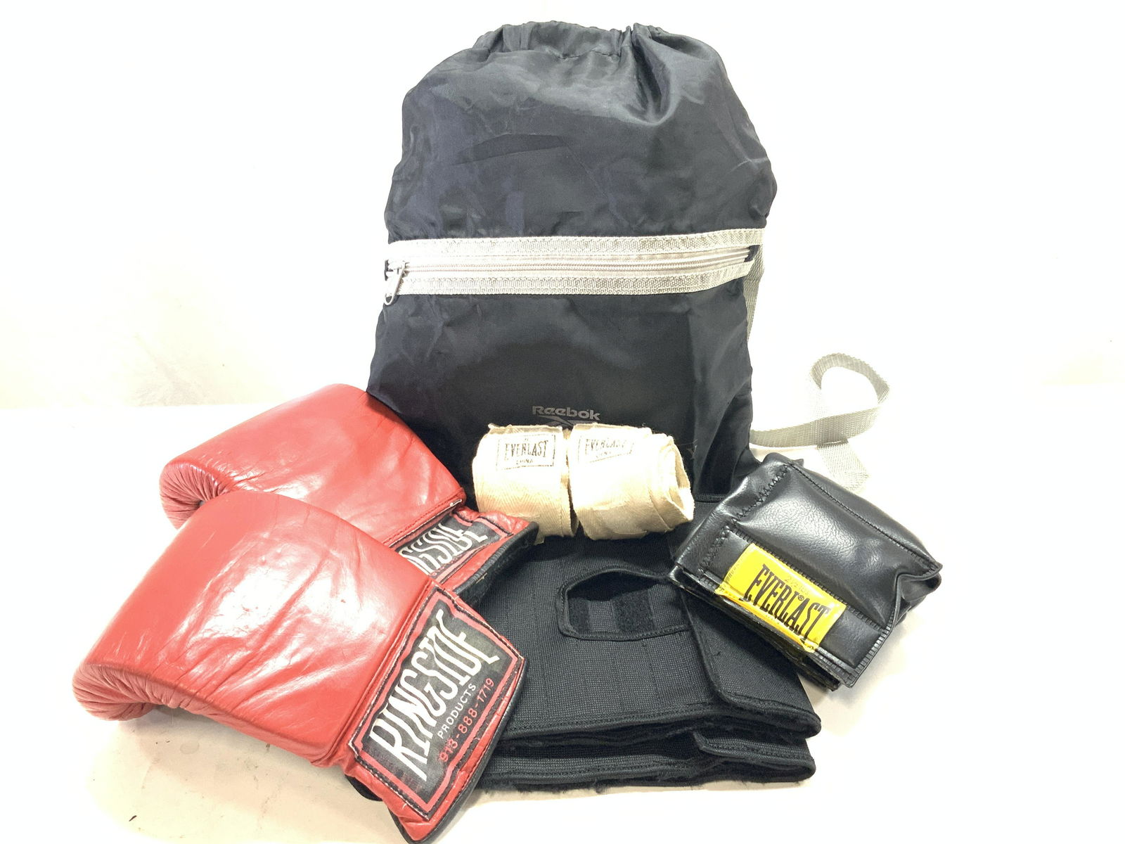 Reebok, RingSide, & Everlasting Boxing Equipment: Reebok sports club draw string bag with 2, 2.5 lbs Everlast brand ankle weights, 2 red Ringside products boxing gloves, 2 Everlast Hand Wraps and 2 Black Velcro athletic wraps. Ankle weights are appro