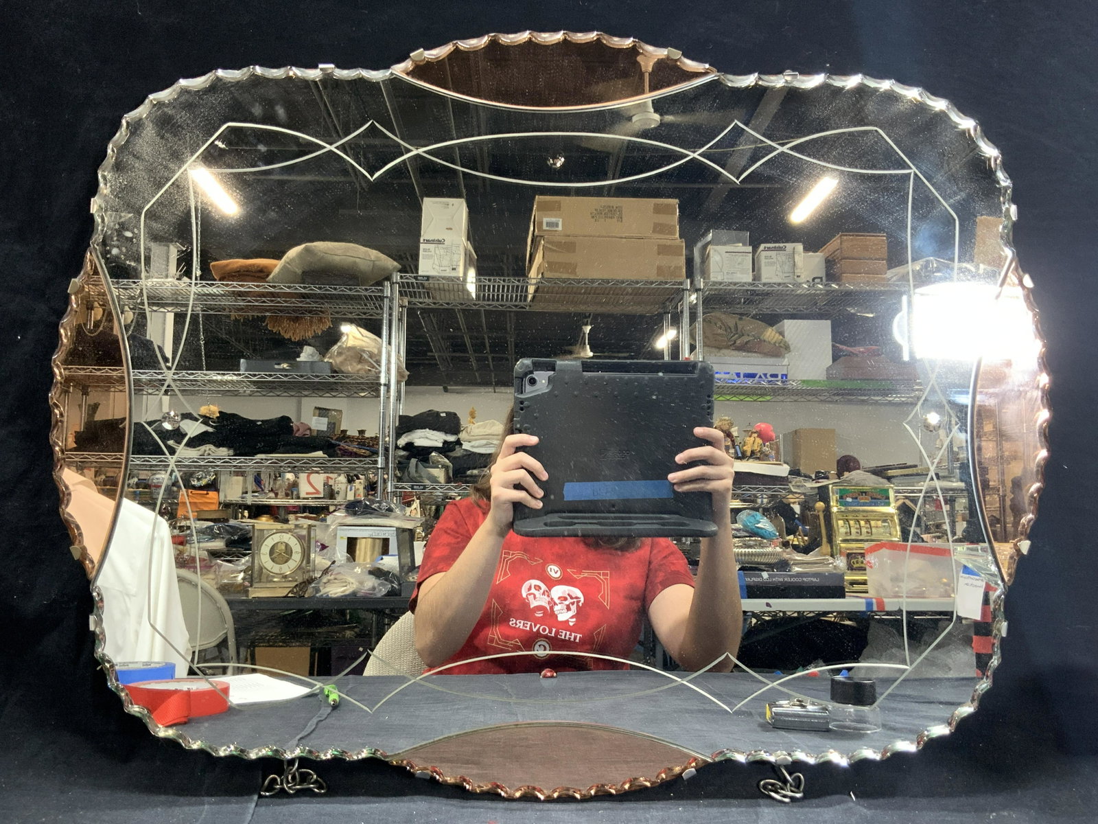 Etched Art Deco Pink & Clear Glass Mirror: An Art Deco style mirror with saw tooth edges and etchings within the center in Geometric patterns. Sides of mirror are adorn with pink toned glass. Approximately 20 x26 inches. Needs replacement hang