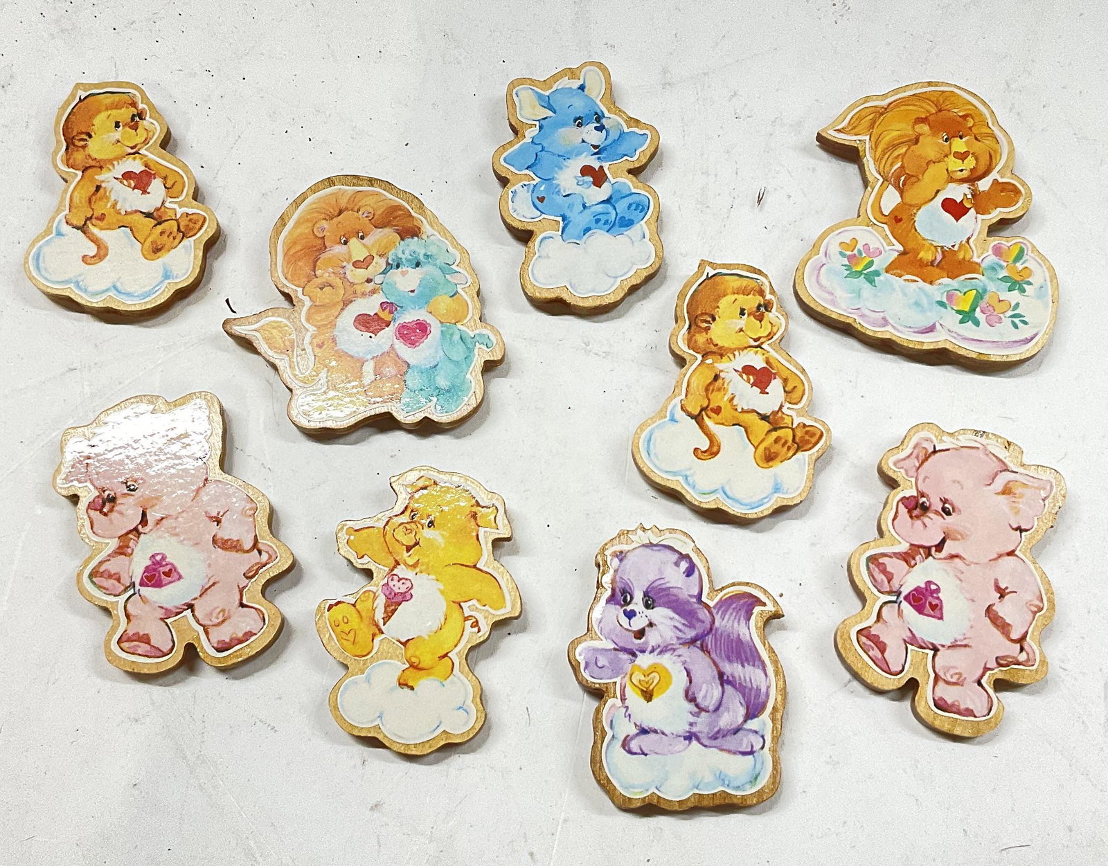 Set 9 Care Bear Cousins Magnets: Care Bear Cousins Magnets. Wood backing, magnets to each one. Largest magnet measures approx 3 x 2.5 inches. Minimal wear to pieces. Magnets, care bear magnets, refrigerator magnets, care bear cousins