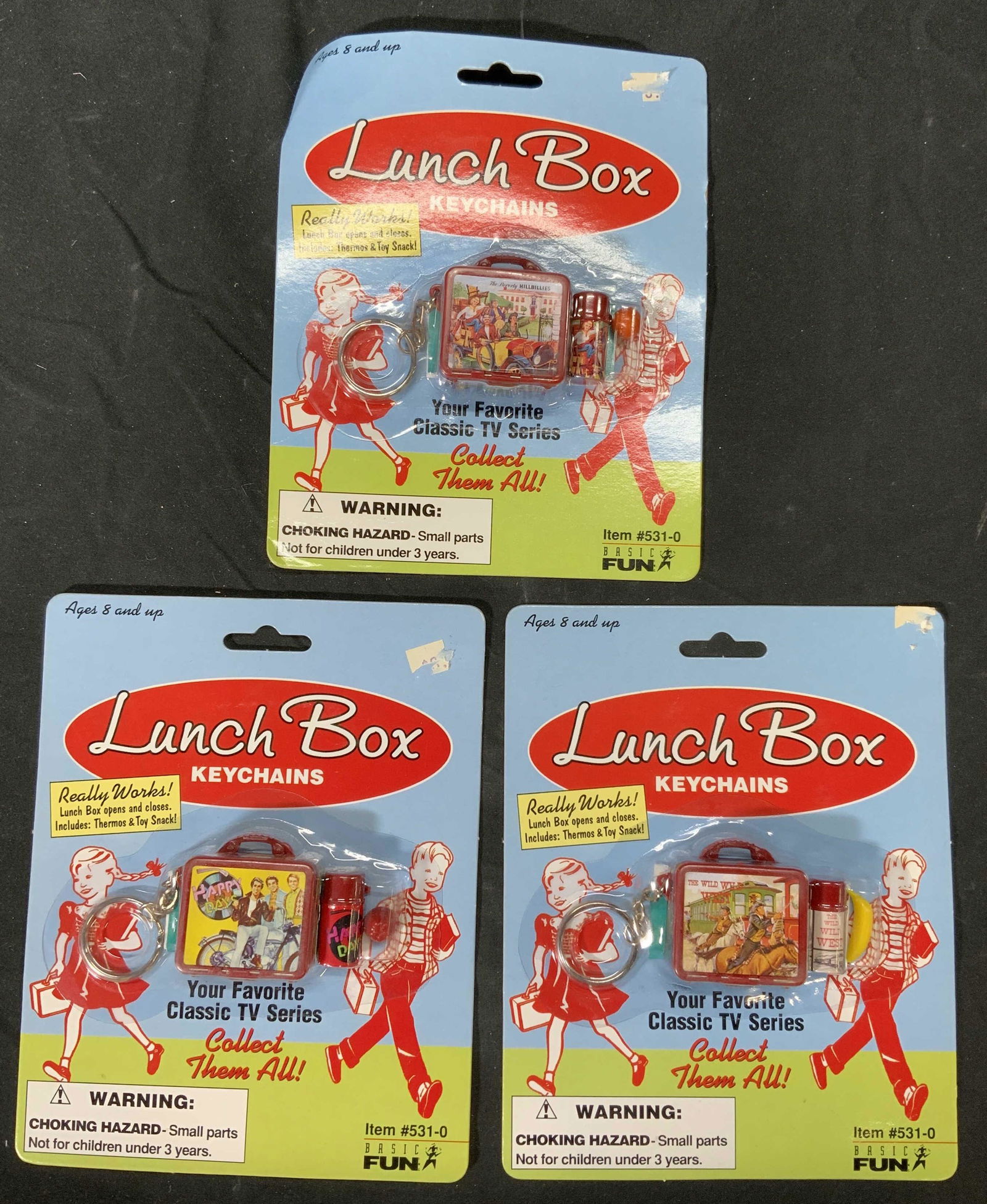 Lot 3 HAPPY DAYS, BEVERLY HILLBILLIES, Keychain: Lot 3 HAPPY DAYS, BEVERLY HILLBILLIES, and THE WILD WEST Keychains. All pieces new in original packaging. Packages measure approx. 7 x 5.5 inches. Happy days, the wild Wild West, Beverly hillbillies,