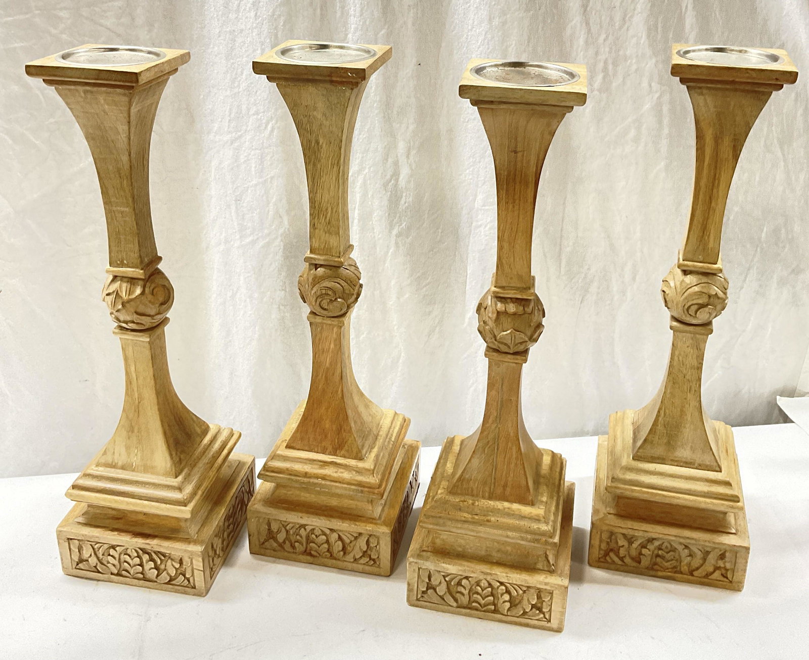 Set 4 Wooden Carved Candle Holders: WOOD Carved Candle Holders. Floral & scroll like carved detail to piece. Light colored wood. Measures approx 20.5 x 6 inches. Surface wear consistent with age and use. Candle holders, wood carved cand