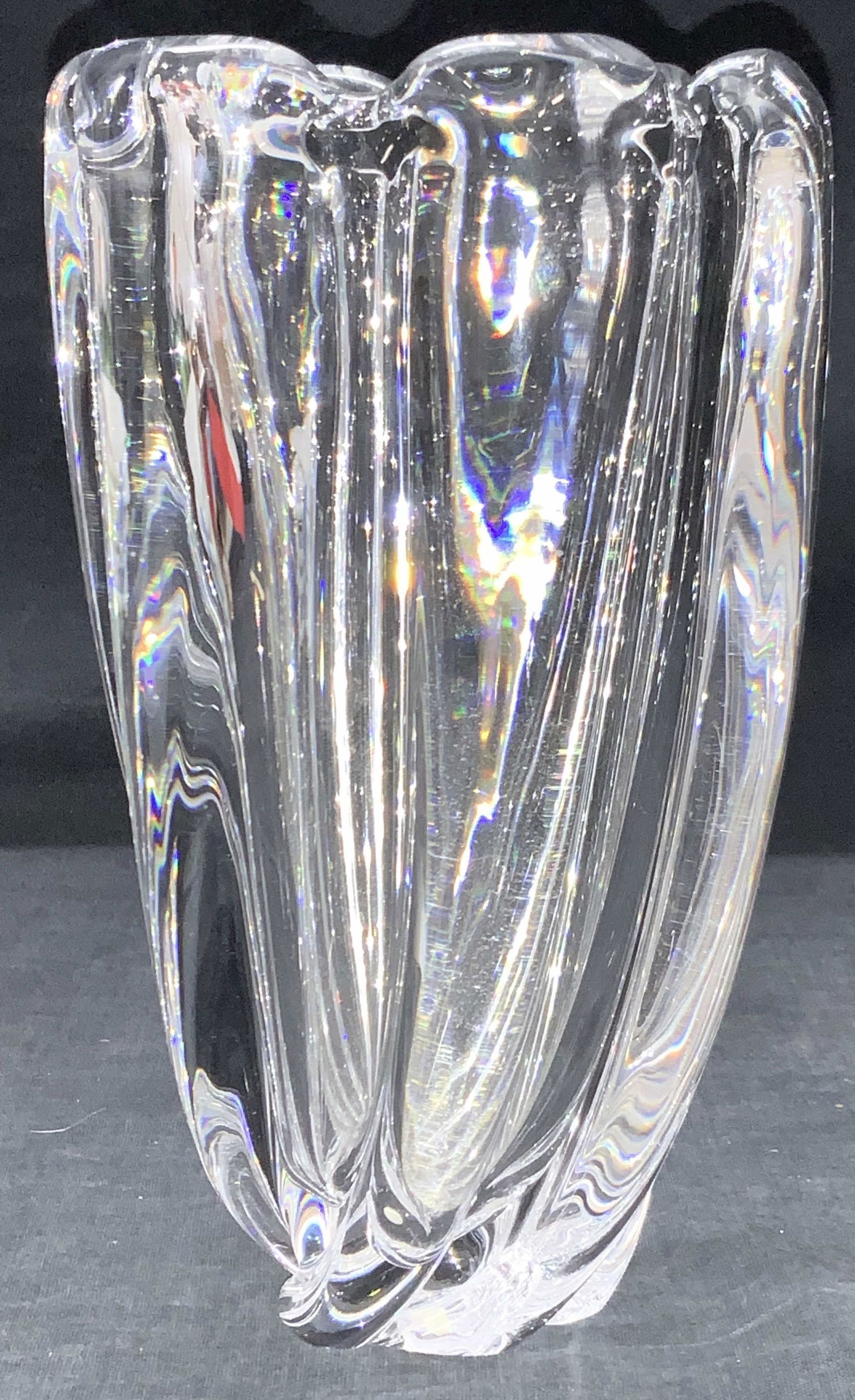 ORREFORS Clear Crystal Vessel: Clear crystal vessel with raised vertical sections on exterior. Body of vessel has spiral shape that tapers or the base. Approximately 7.75 inches tall. Signed on underside ORREFORS. Orrefors crystal