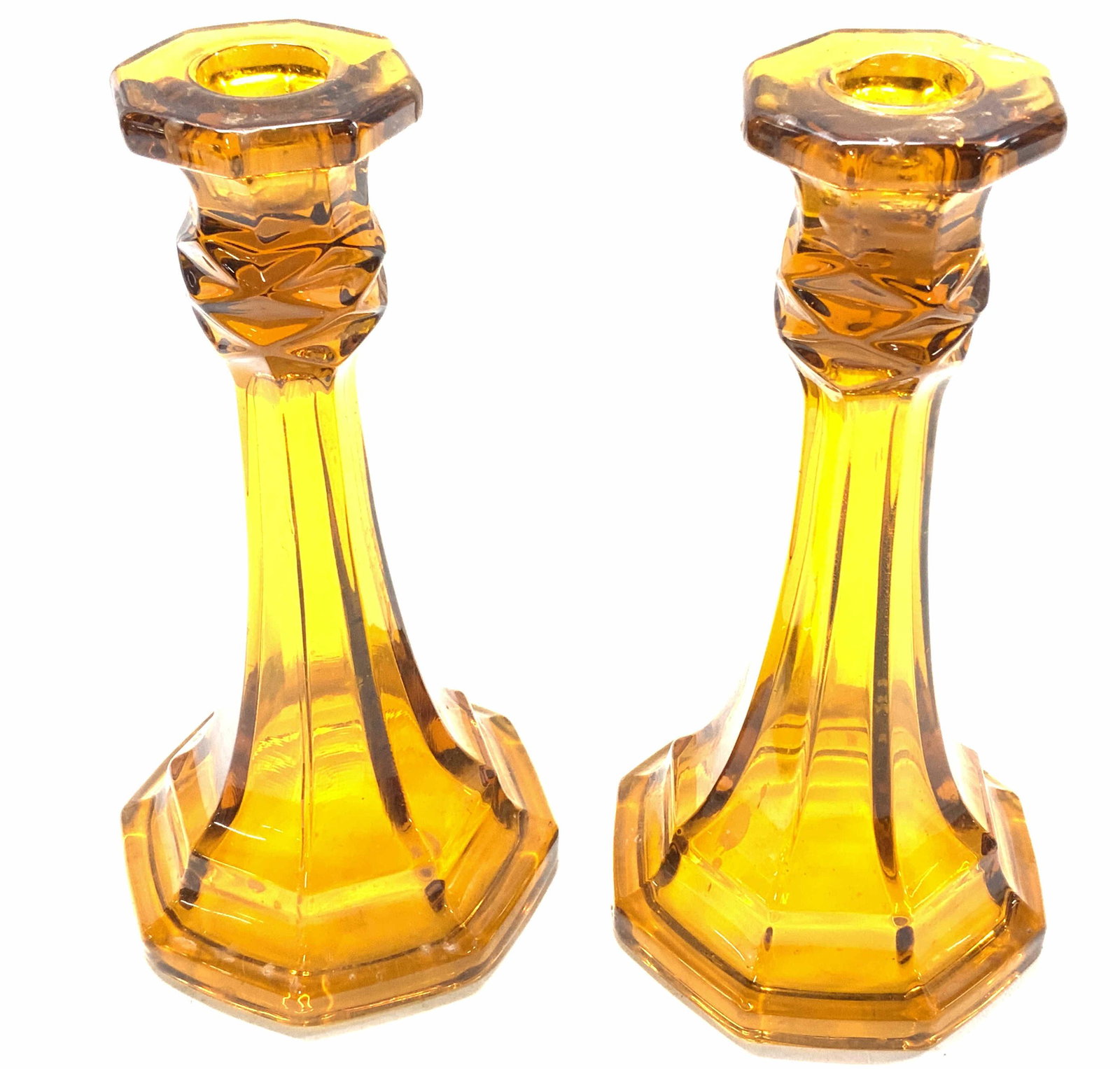 Lot 2 Vintage Amber Glass Candle Holders: Set of 2 vintage amber glass candle holders. Measure approx. 4 5/8 x 4 5/8 x 9.25 inches. In good condition, need cleaning. Amber glass, glass candle holder, glasswork, studio glass, decorative candle