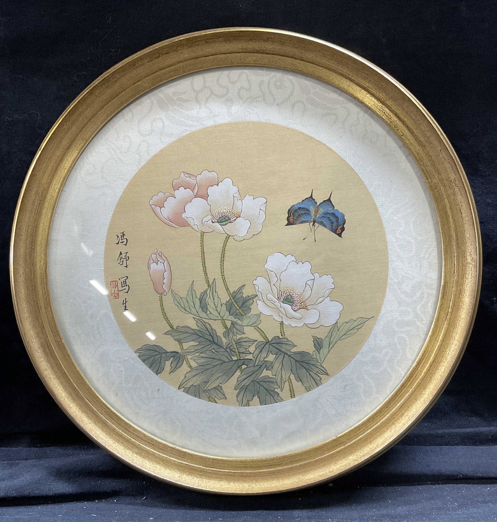 Feng Shu Signed Watercolor Painting: Feng Shu Signed Watercolor Painting, artist signature to left, subject a blue butterfly approaching white flowers, measures 11 1/2 inches in diameter, gilt wooden frame, surface wear to frame, profess
