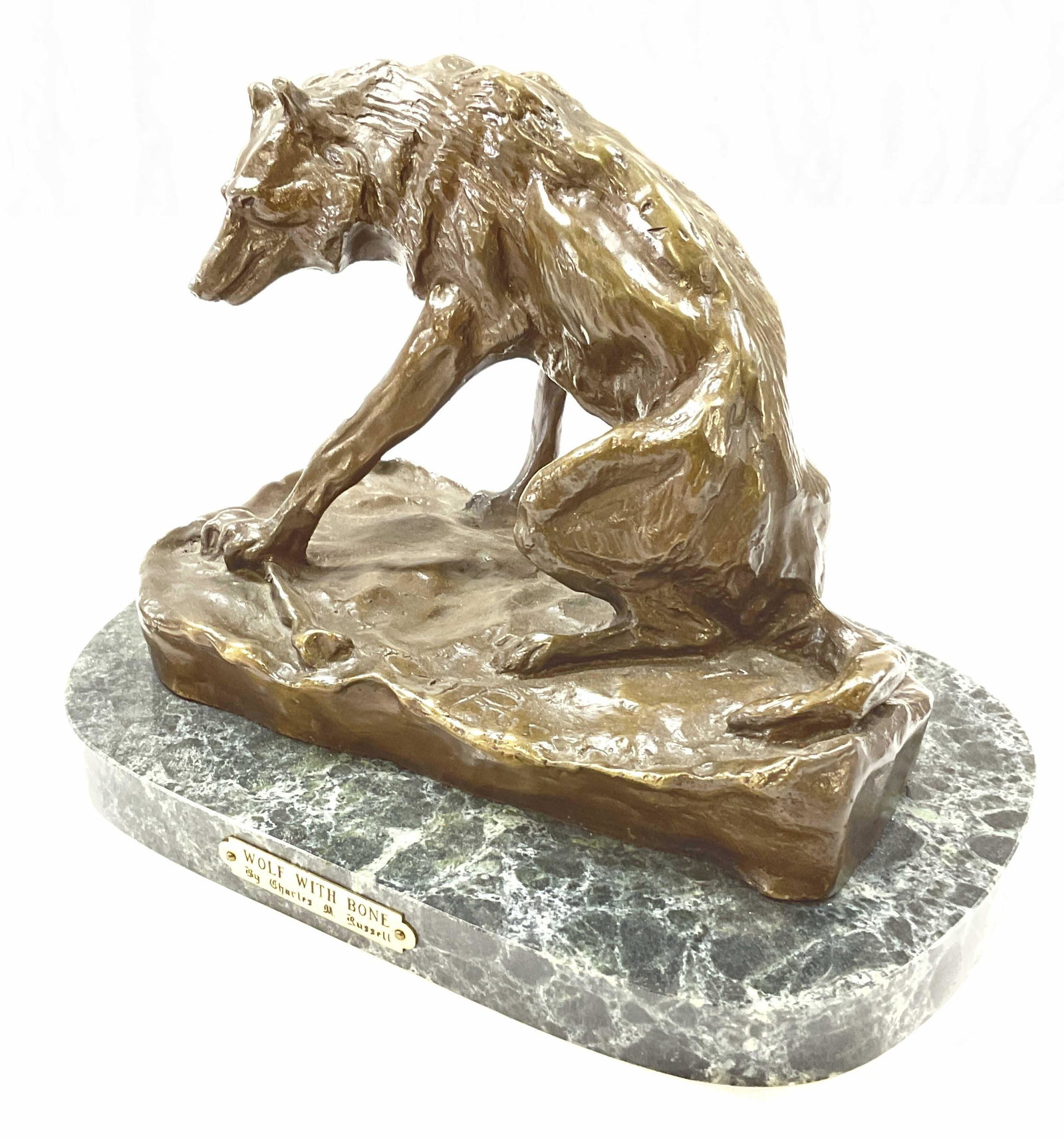 Signed Bronze, Wolf W Bone, Charles Russell: Signed Bronze, Wolf W Bone Sculpture. Signed by Charles M. Russell. Marble base. Measures approx 8.5 x 5.5 inches. Minimal wear to piece. Bronze sculpture, bronze, bronze decor, wolf with bone, signed