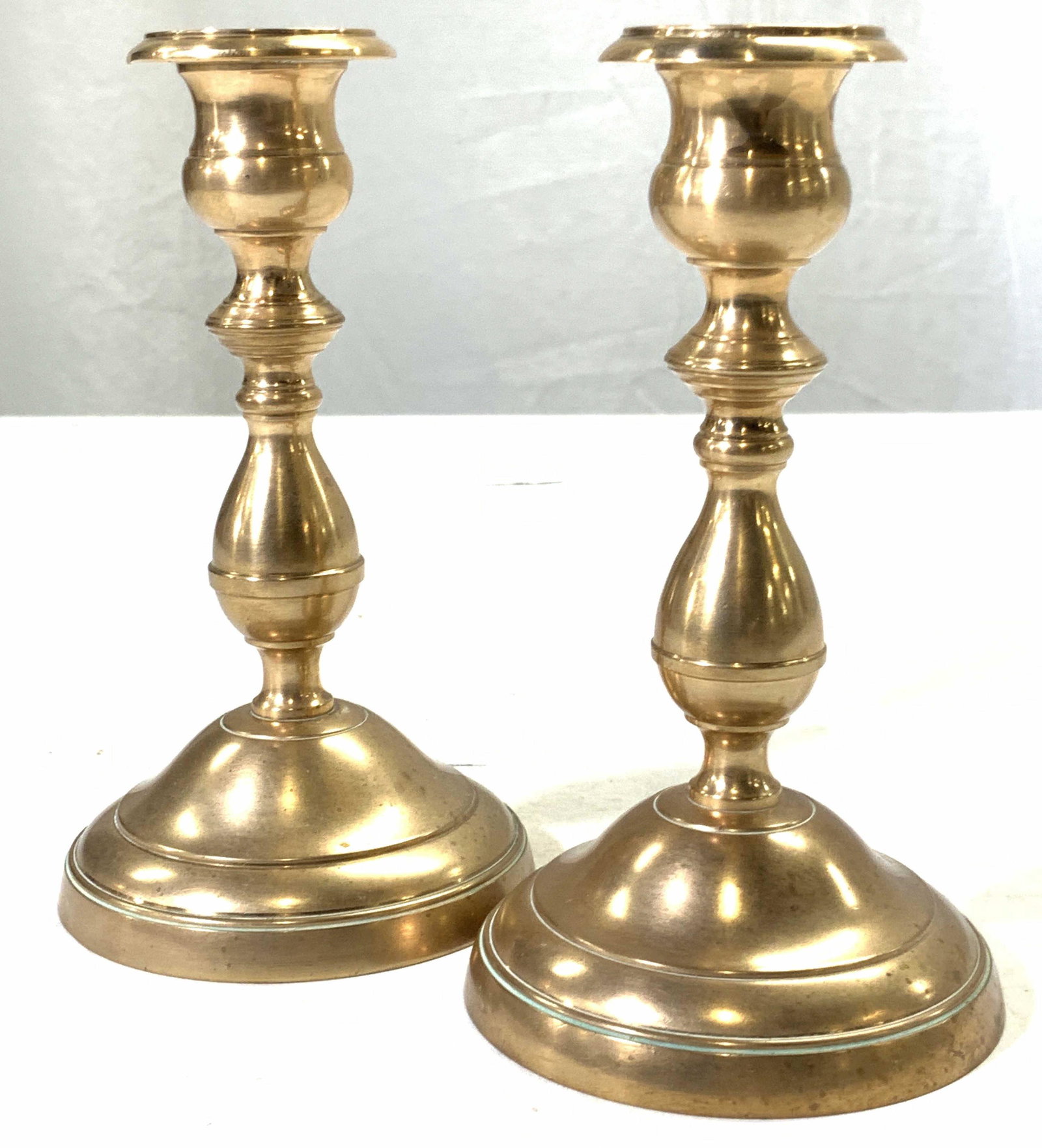 Pair of Brass Candle Sticks: Pair of brass made candle sticks. Approximately 5.5 inches tall. Evident oxidation to brass. Brass candle sticks, candle sticks, brass ware, mantle accessories, home decor, home accessories and decor,