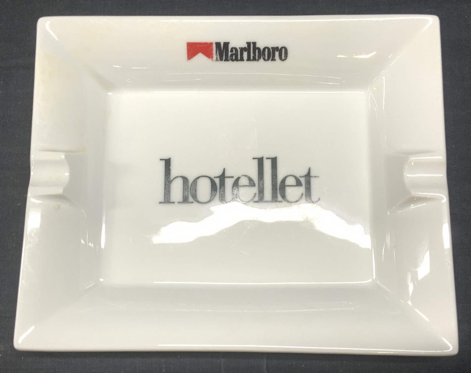 YVES DESHOULLIERES Marlboro Hotellet Ashtray, FR: YVES DESHOULLIERES Marlboro Hotellet porcelain Ashtray, France, with Marlboro logo, signed verso, surface wear, measures approx 7 3/4 x 6 1/4 x 1 1/4 in. YVES DESHOULLIERES Marlboro Hotellet Ashtray, 