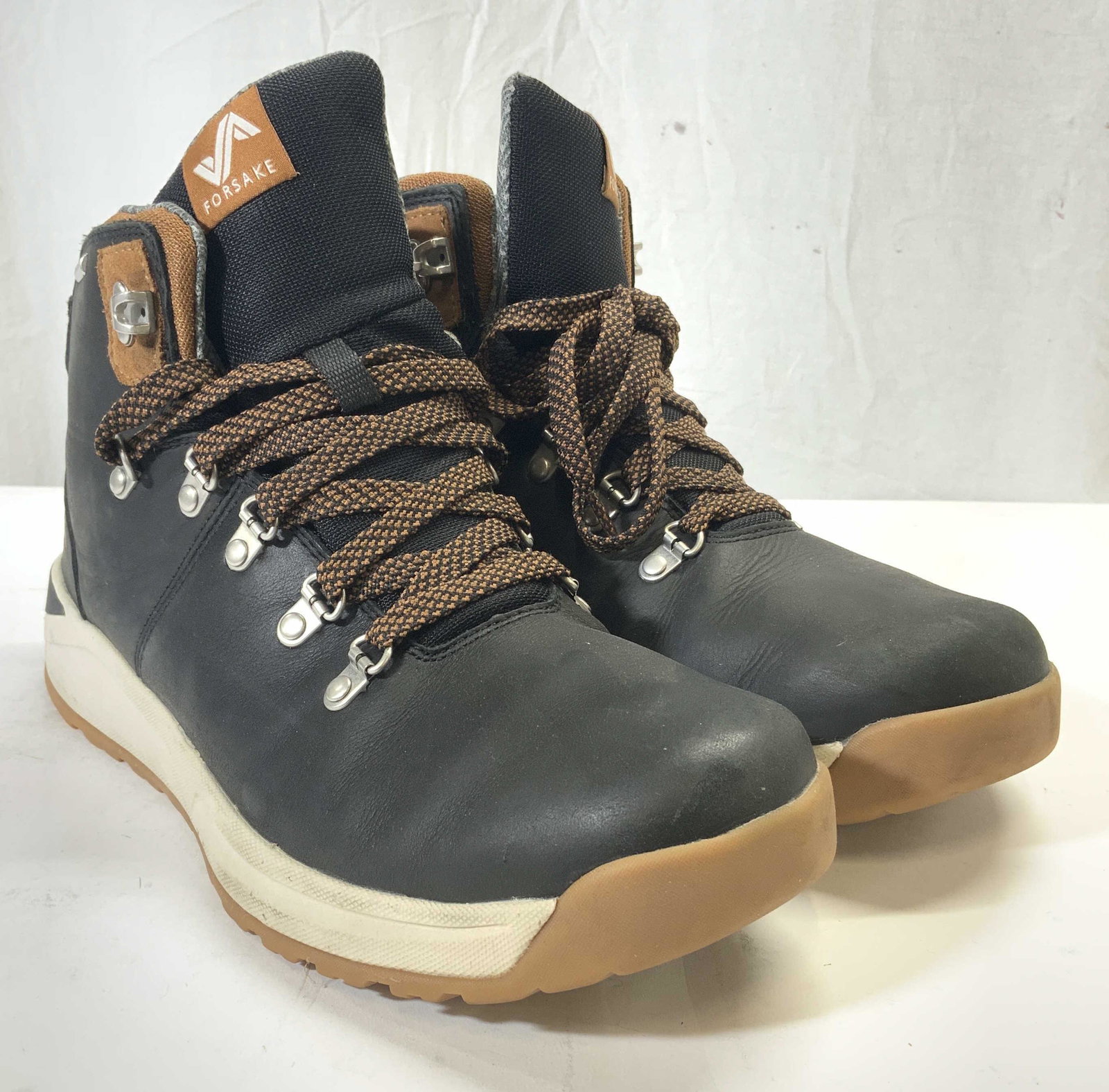 FORSAKE Waterproof Hiking Books Size 10.5: Boot Tongue tag reads FORSAKE. Boots are black with cream & tan toned outsoles. Laces are brown & black toned. Boots are size 10.5. Boots, waterproof boots, hiking boots, forsake boots, footwear, mens