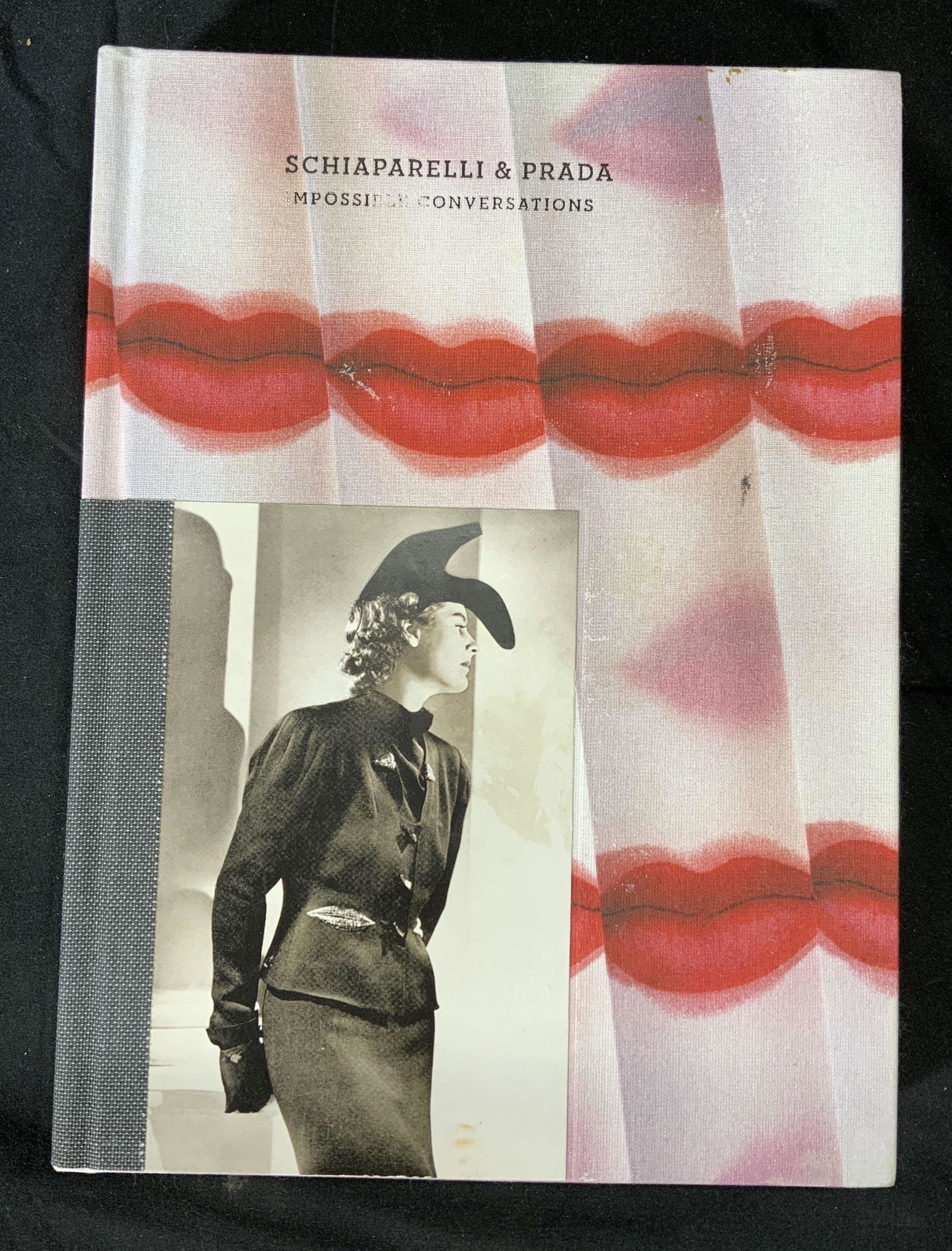 SCHIAPARELLI & PRADA Impossible Conversations: Hardcover copy of Schiaparelli & Prada Impossible Conversations exhibition catalog. Published by The Metropolitan a museum of Art, 2012. Some wear to cover consistent with exposure. 10 5/8 long by 7 3