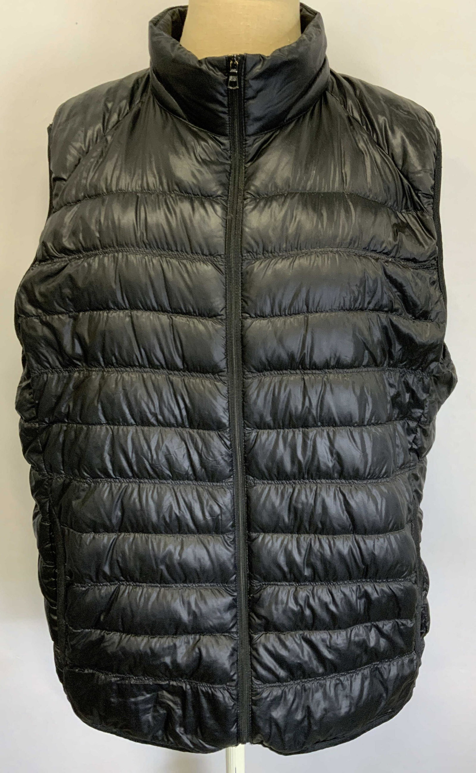 UNIQLO Black Puffer Vest: Uniqlo puffer vest with front zipper in black. Size L. Possibly synthetic blend. Gently worn. Uniqlo, Uniqlo vest, ladies contemporary designer, ladies contemporary fashion, ladies designer vest, ladi