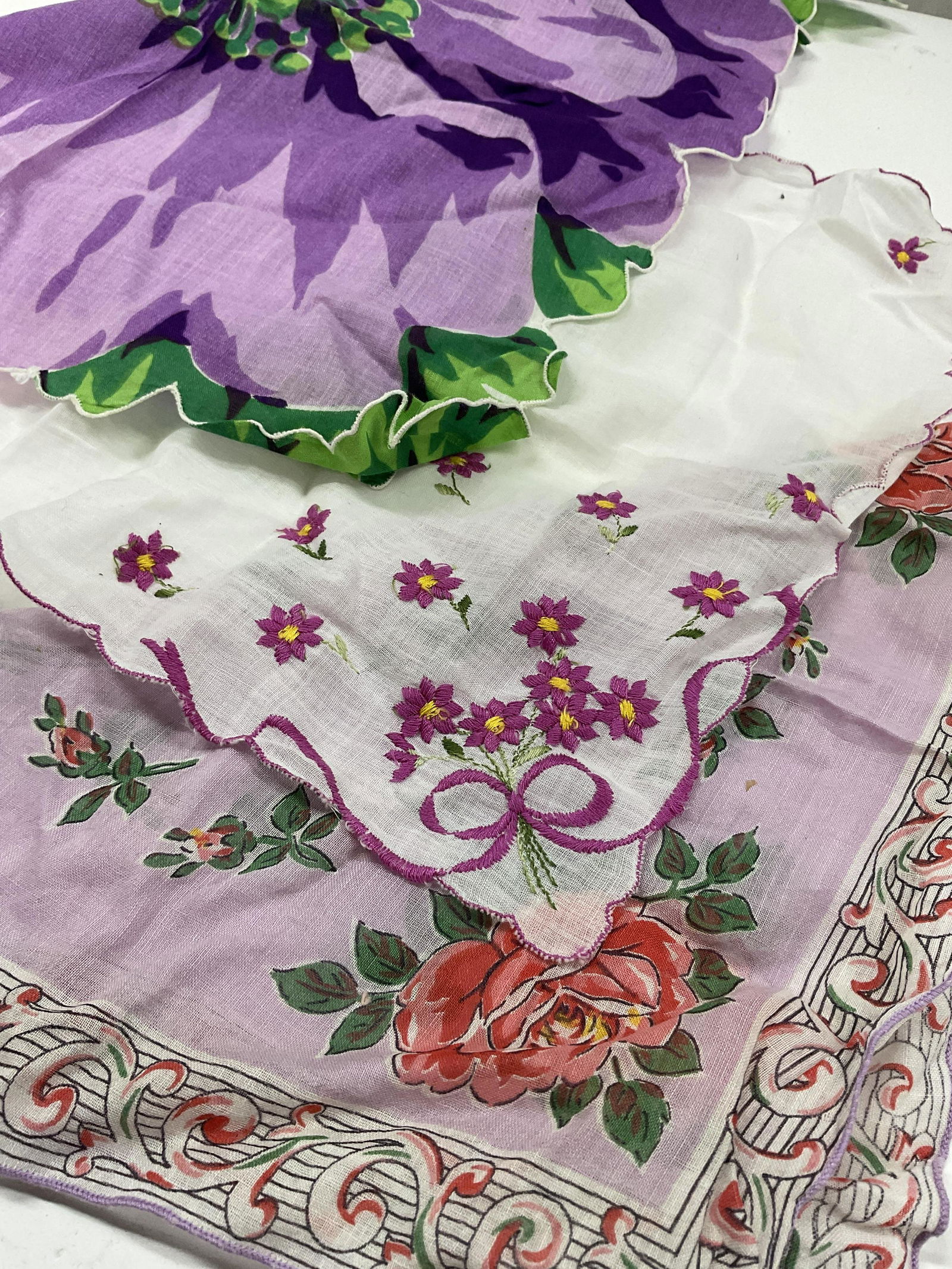 Lot 2 Purple Floral Handkerchiefs: Vintage floral handkerchiefs or doilies. Largest measures approx 12 x 11 Measures approx Minimal wear, minor stain to fabric. Handkerchiefs, floral handkerchiefs, doily, floral fabric, up-cycle doilie