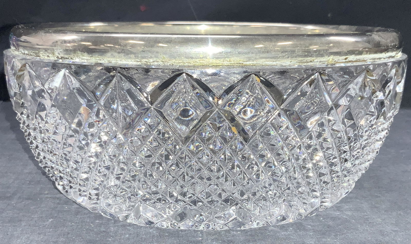 Vintage Hand Cut Crystal Metal Rimmed Bowl: Vintage hand cut crystal bowl with white metal rim, bowl is hand cut with checkered patterns on exterior. Approximately 4 inches tall and 8 inch diameter. Vintage hand cut crystal bowl, crystal bowl,