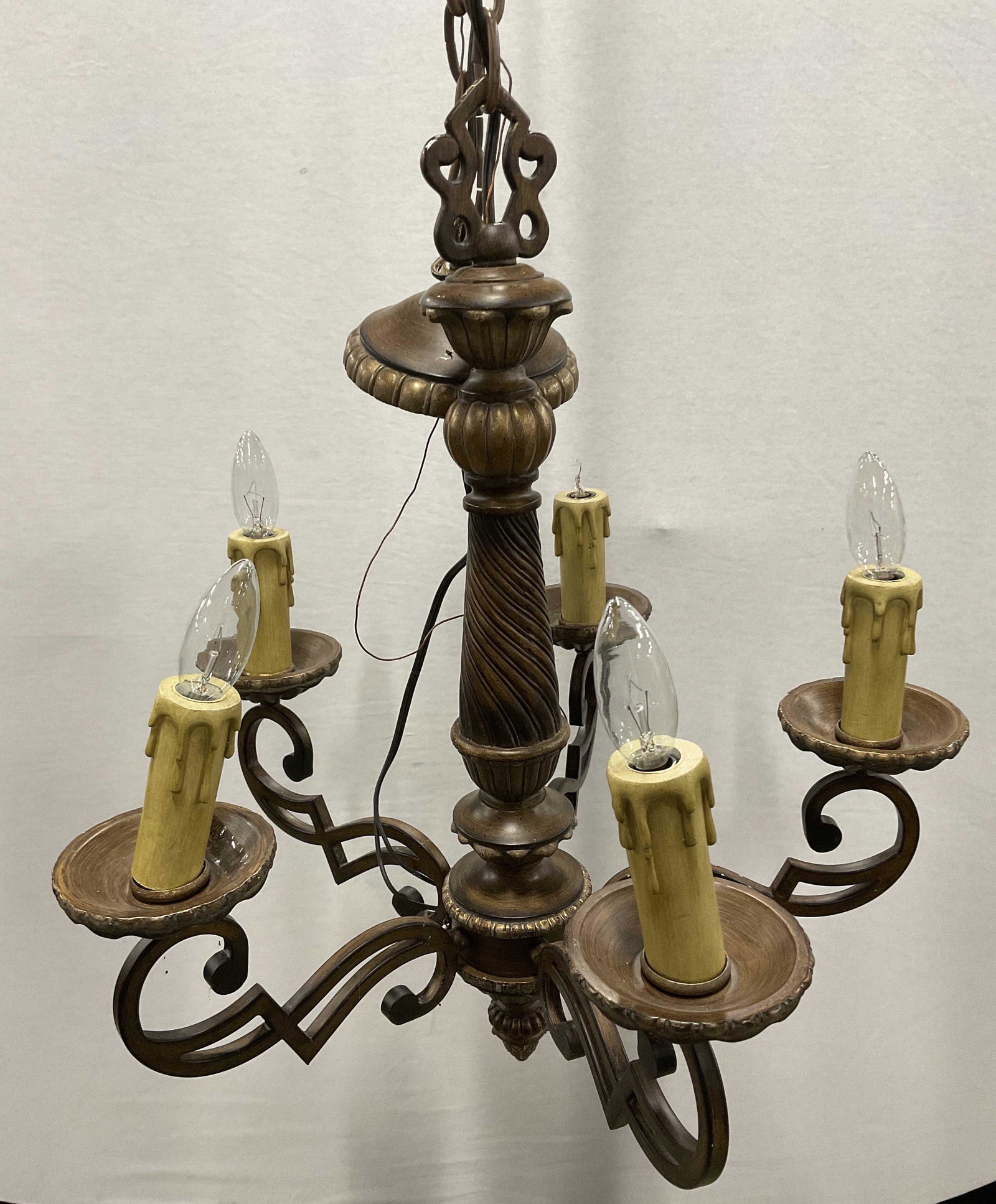 5 Armed Chandelier: Chandelier measures approx 22h x 19w inches. Chandelier possibly made out composite material made to look like wood. 4 bulbs to piece. Not tested for functionality. Surface wear to piece consistent wi