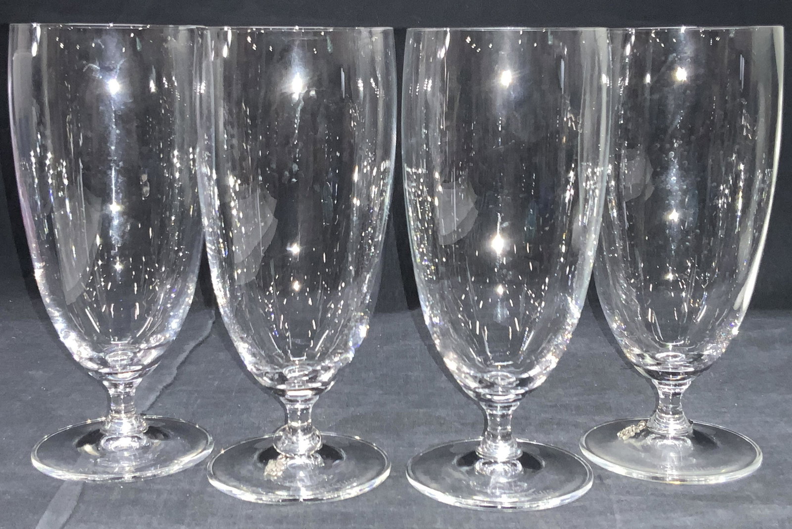 Set4 MARQUIS Waterford Pilsner Style Crystalwares: Set of 4 crystal Pilsner style glasses with stem feet and long bodies. 3 out of the 4 have bull wine glass charms. All are marked Marquis by Waterford on bases. Approximately 7 inches tall. Marquis Wa
