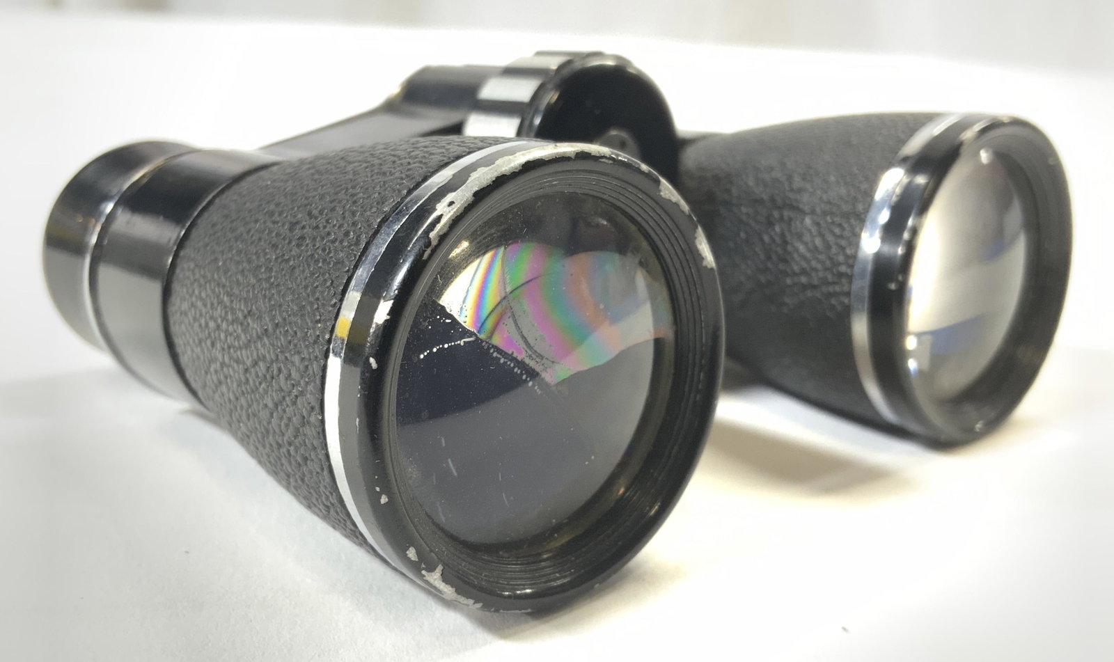 TASCO 4 X 30 Binoculars: Binoculars are inscribed TASCO 4 X 30 Coated. Piece is black and silver toned. Appears to be rubber & metal. Piece has adjustment knob in center. Piece bends to fit to face. Measures approx 4 inches w