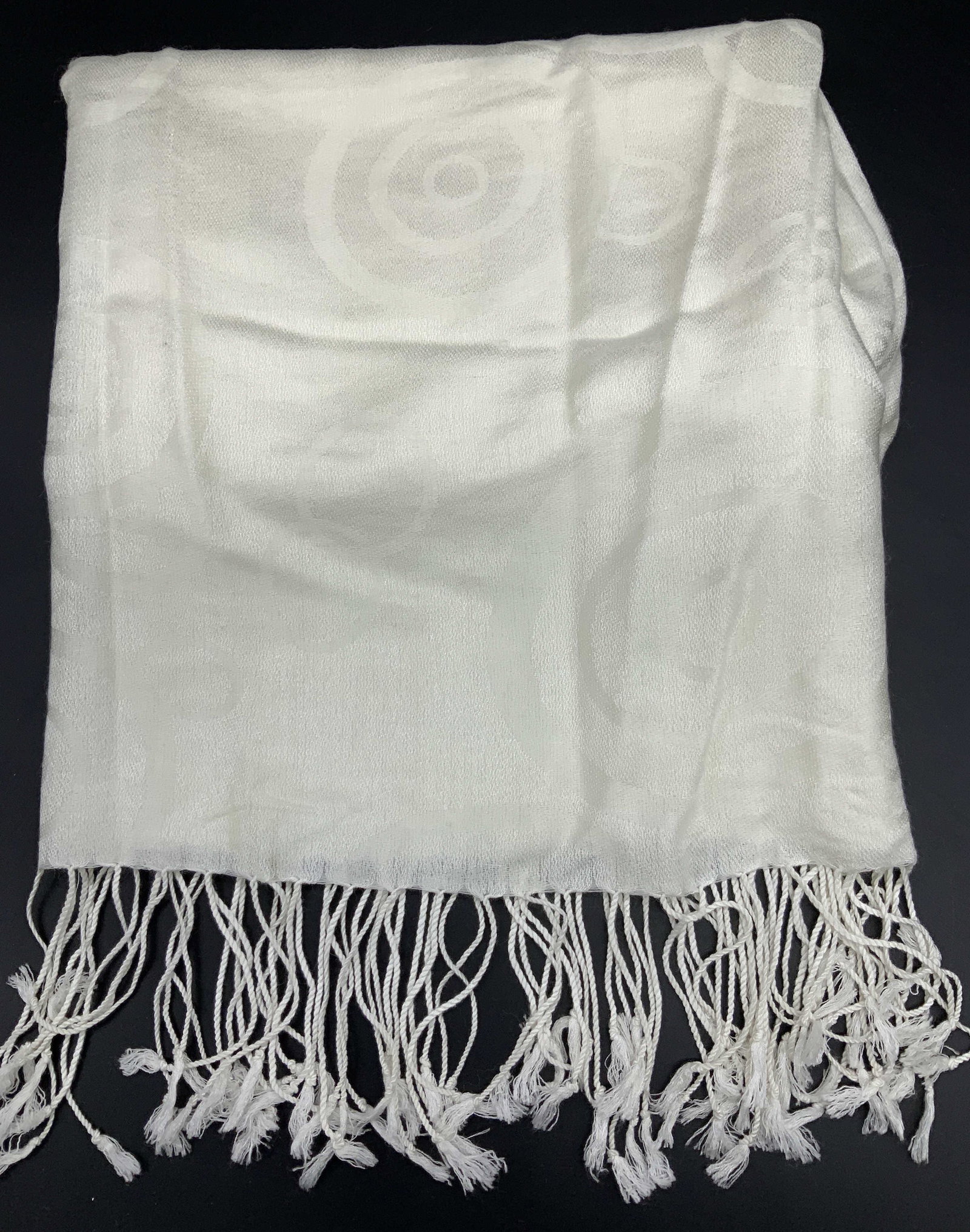 Off White Tassel Shawl w/ Circle Design: Off white shawl with end tassels. Tone on tone circle pattern. Soft hand fabric , no label attached. Shawl measures 26.75 x 66 in. Appears new. Minor wear including thread pulls. Ladies wearables acce