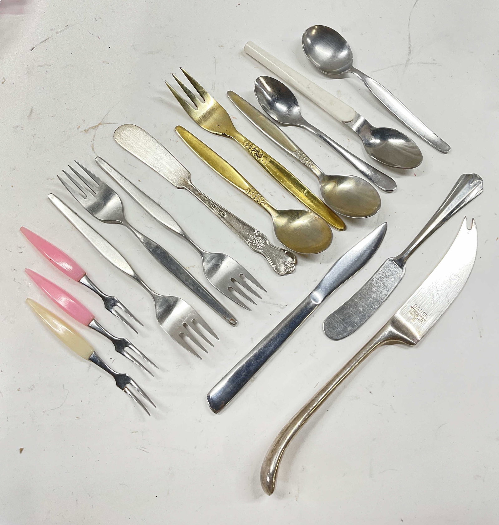 Lot 16 Variety Of Silverware Pieces, Italy More: Lot 16 Variety Of Silverware Pieces. Most pieces are marked. Markings include, Made in Italy, Dansk, Nica Rostfrei, Windsor. Largest Measures 8.25 inches. All have surface wear to exterior. Cocktail f