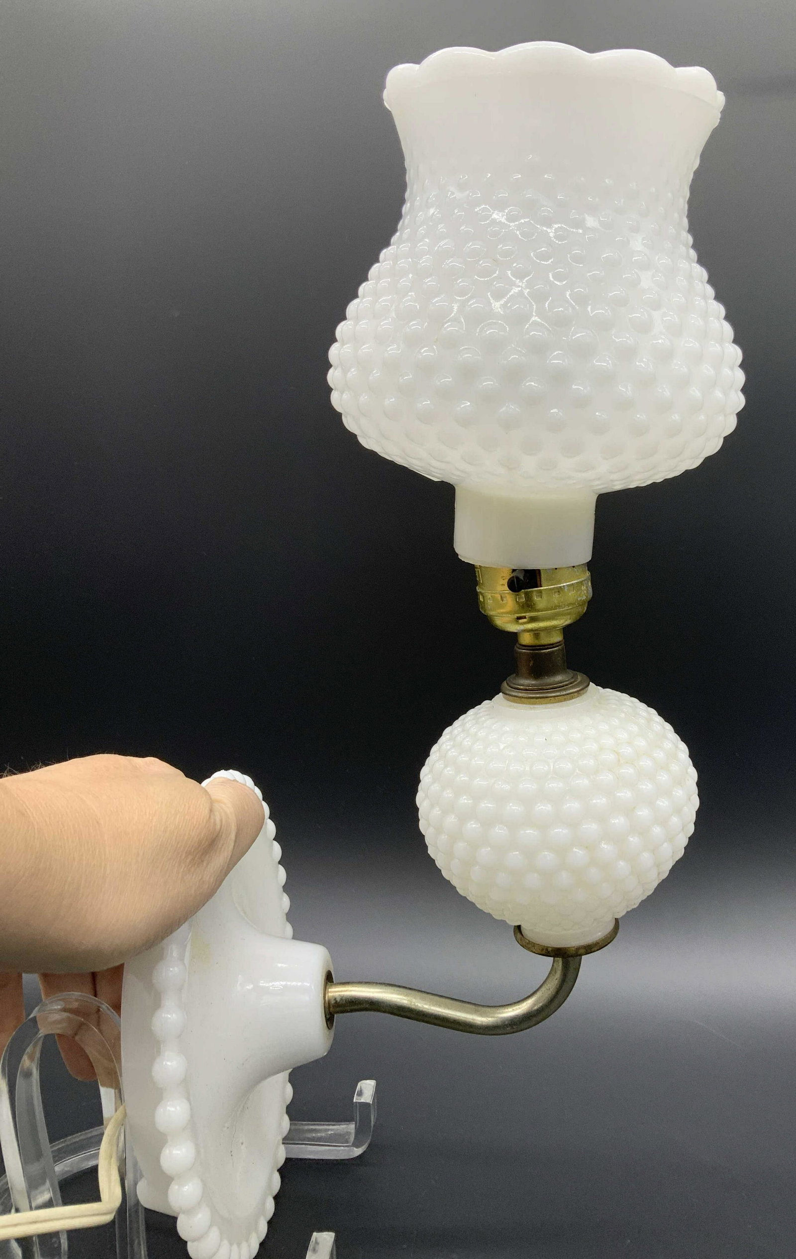 Colonial Style Hobnail Milk Glass Sconce Lamp: Mid century colonial farmhouse style hobnail milk glass sconce lamp. Wall base measures 6.5 in. diameter, total Ht app 14 in. Lamp need a piece that holds up the lamp shade. Not tested for working con