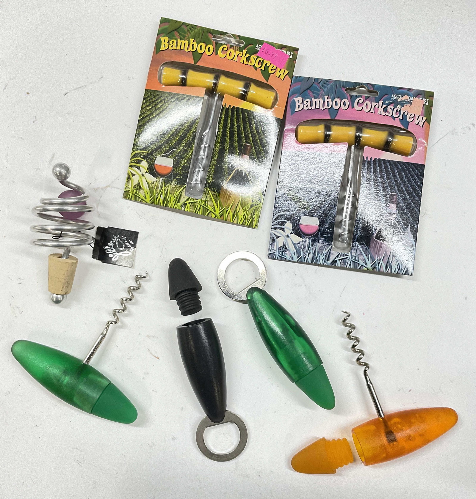 Set of Barware Accessories, Cork Screw & More: Set of Barware Accessories. 2 cork screws in packaging, 2 cork screws with built in bottle stopper. 2 bottle openers with built in bottle stoppers and a wine stopper, new with tag. Minimal wear to pie
