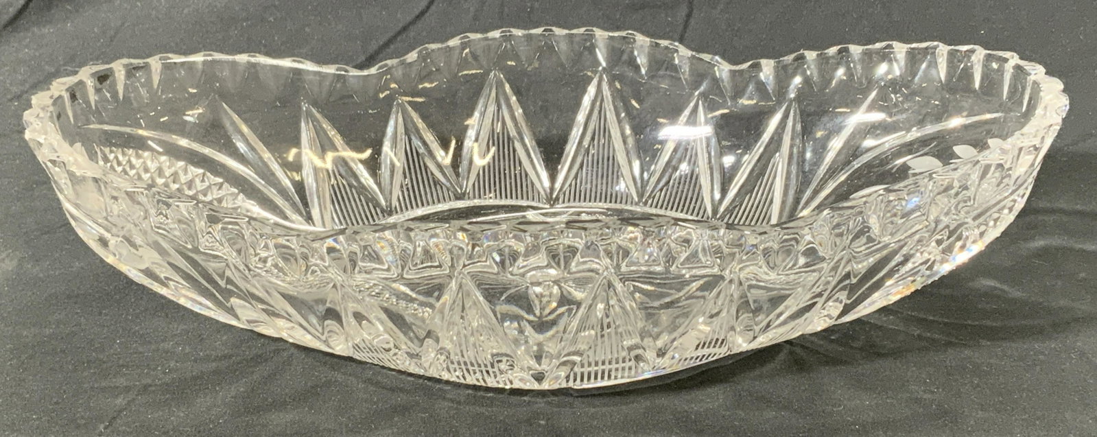 Vintage Saw Tooth Cut Crystal Centerpiece Bowl: A vintage cut crystal bowl with saw tooth rim. Some wear consistent with age and exposure. Measures approx. 12 x 7 x 2 5/8 inches. Crystal bowl, Crystalware, art glass, cut crystal, table decor, table
