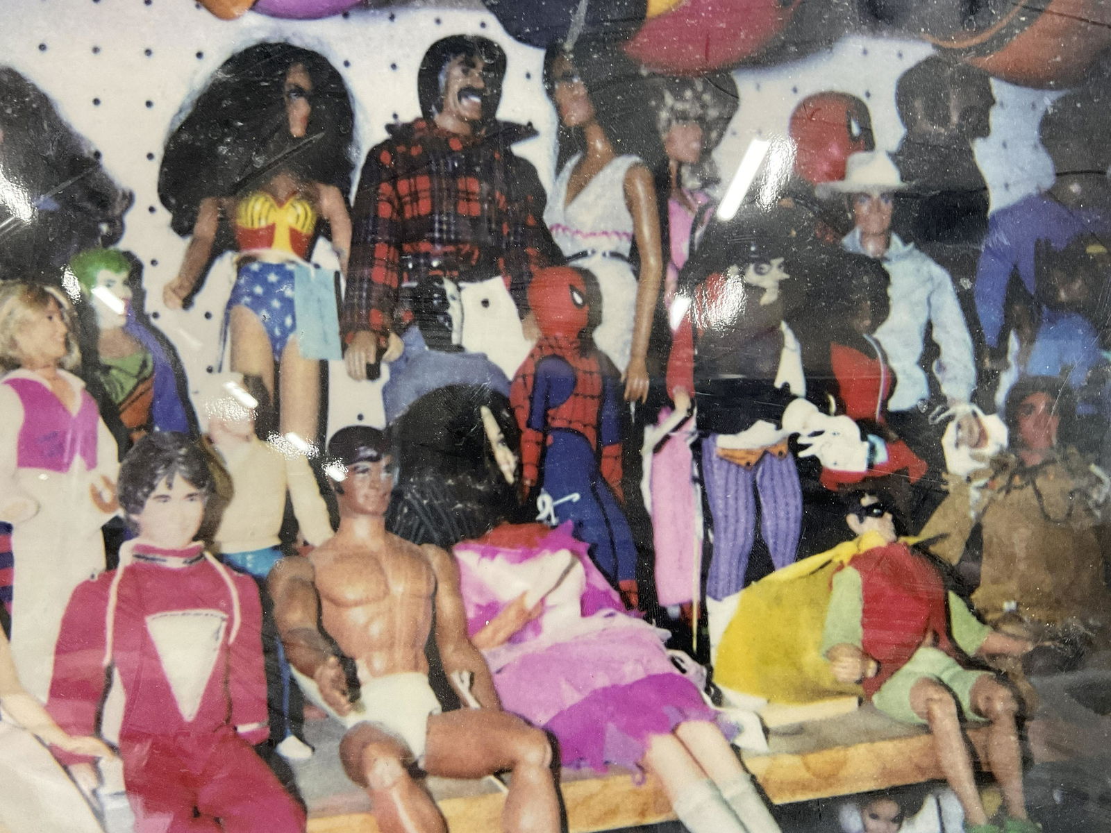 Photograph of Vintage Dolls and Action Figures: Photograph of Vintage Dolls and Action Figures, no apparent inscriptions or signatures to piece, not examined out of frame, subject a photograph of dolls, action figures, and cups in a store, measures
