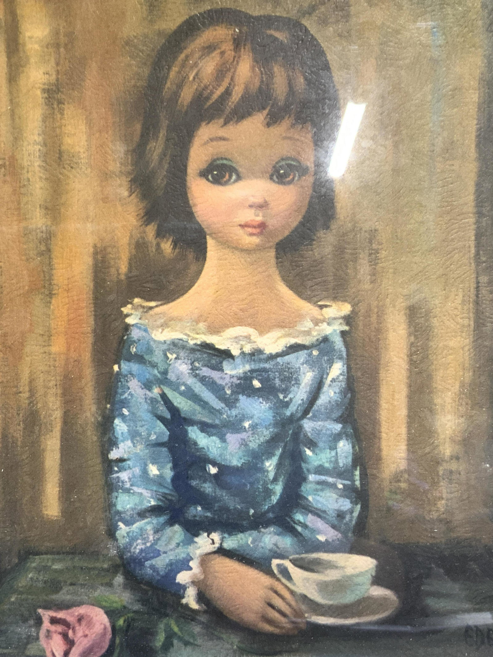 EDEN Big Eyed Girl At Table Lithograph: EDEN Big Eyed Girl At Table Lithograph, inscribed Eden in lower right, subject shows a little girl with a sad look on her face sitting at a table with a cup and saucer and a rose, in frame measures ap