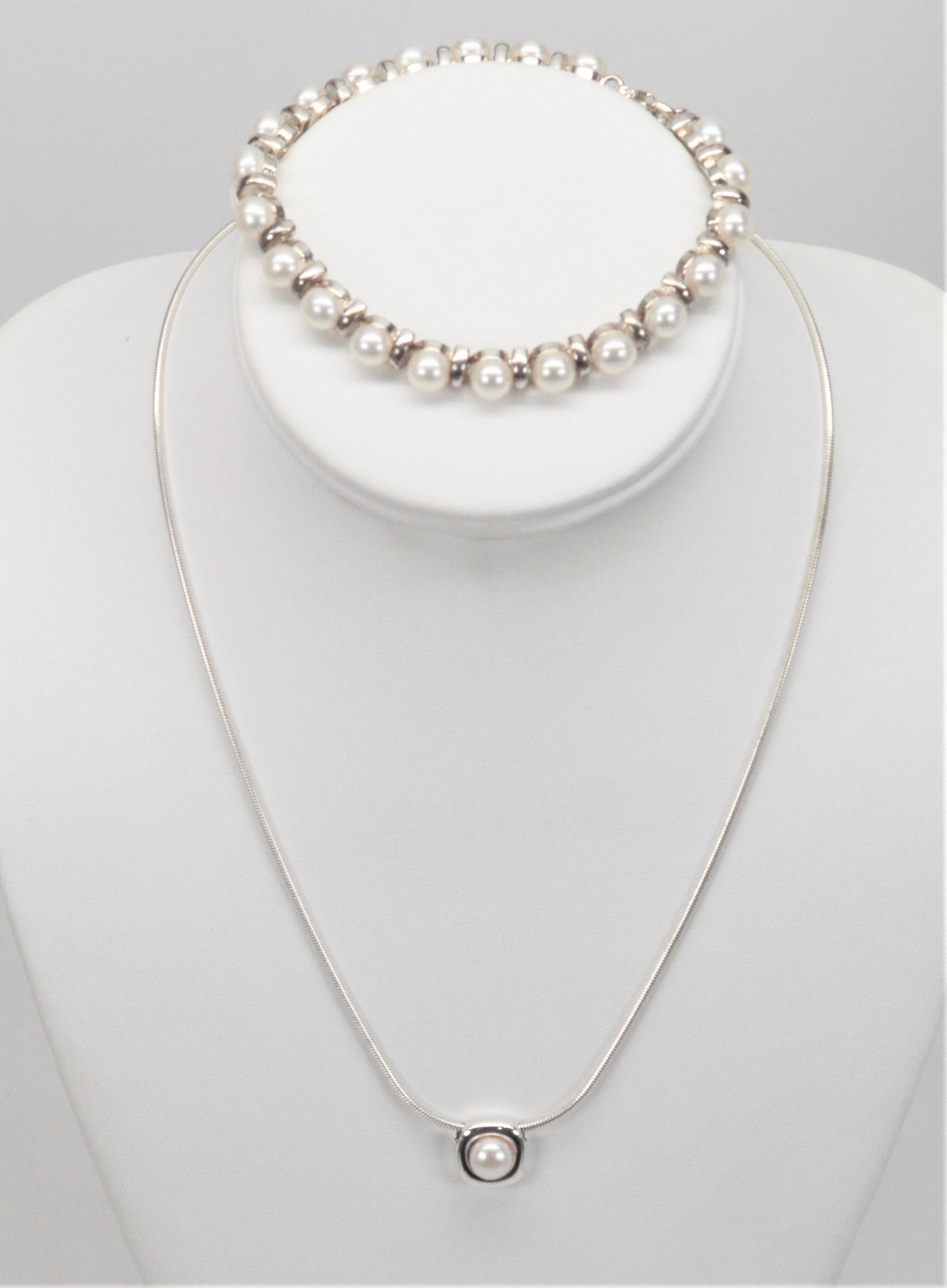 lot2 Silver & Faux Pearl Line Bracelet W Necklace: Silver and Faux Pearl Line Bracelet and Complimenting Necklace. Sterling Silver 17" Necklace Holds a Silver and Faux Pearl Sliding Pendant. The 6.5" Line Bracelet is Made of Silver and Faux Button Pea