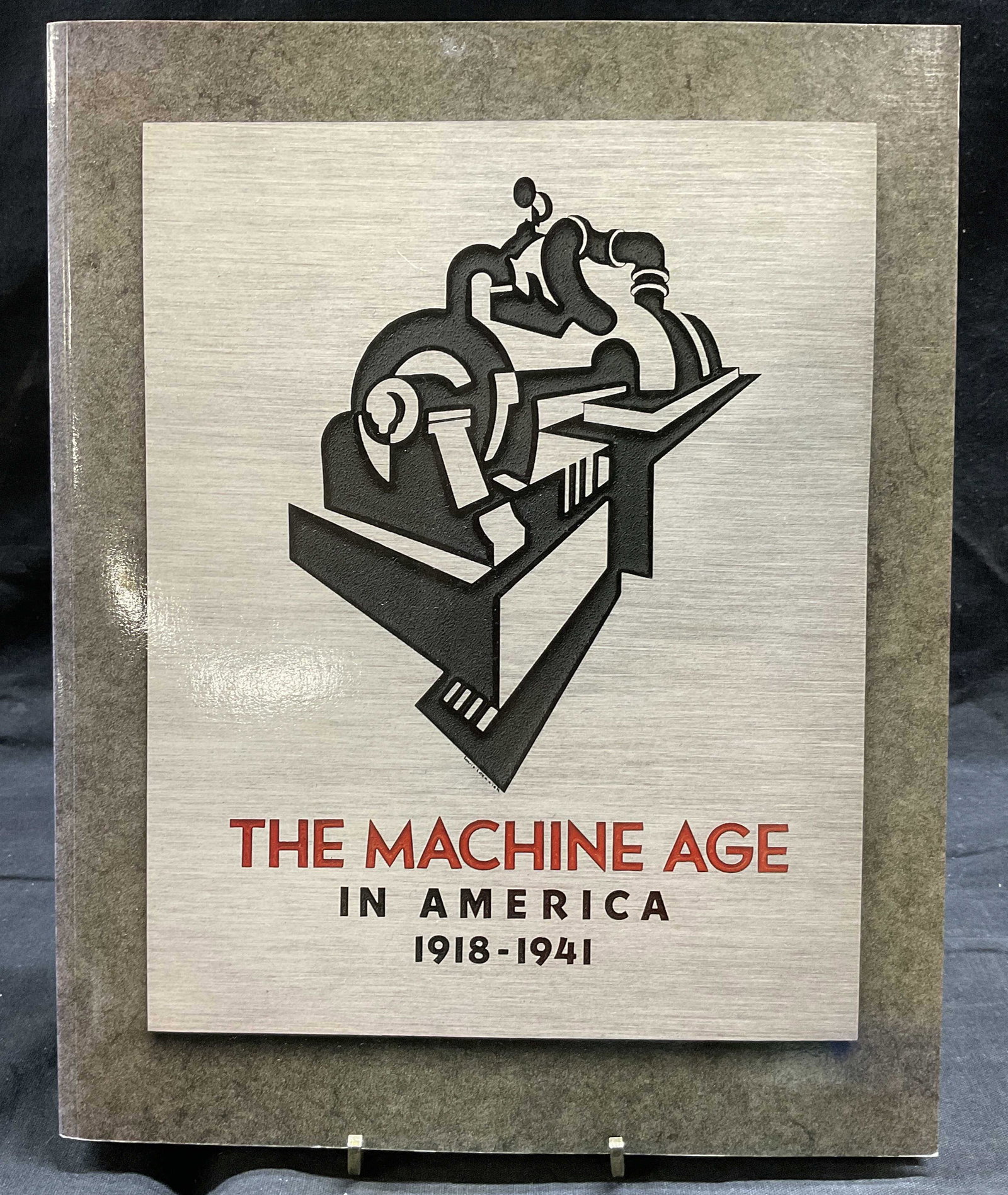 The Machine Age in America Coffee Table Book: The Machine Age in America Coffee Table Book, inscription reads The Machine Age in America. 1918-1941, Published in 1986 by Harry N Abrams, measures 11 x 8 3/4 inches, surface wear to piece, Photograp