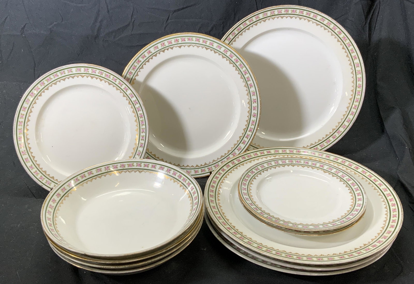 Set 12 GDA LIMOGES Floral Dishware Set: Set of 12 GDA LIMOGES porcelain plates with gilt details and floral motif. Includes 2 bread and butter plates (approx. 6.25 inches diameter), 4 soup bowls (approx. 7.5 inches diameter), 1 appetizer pl