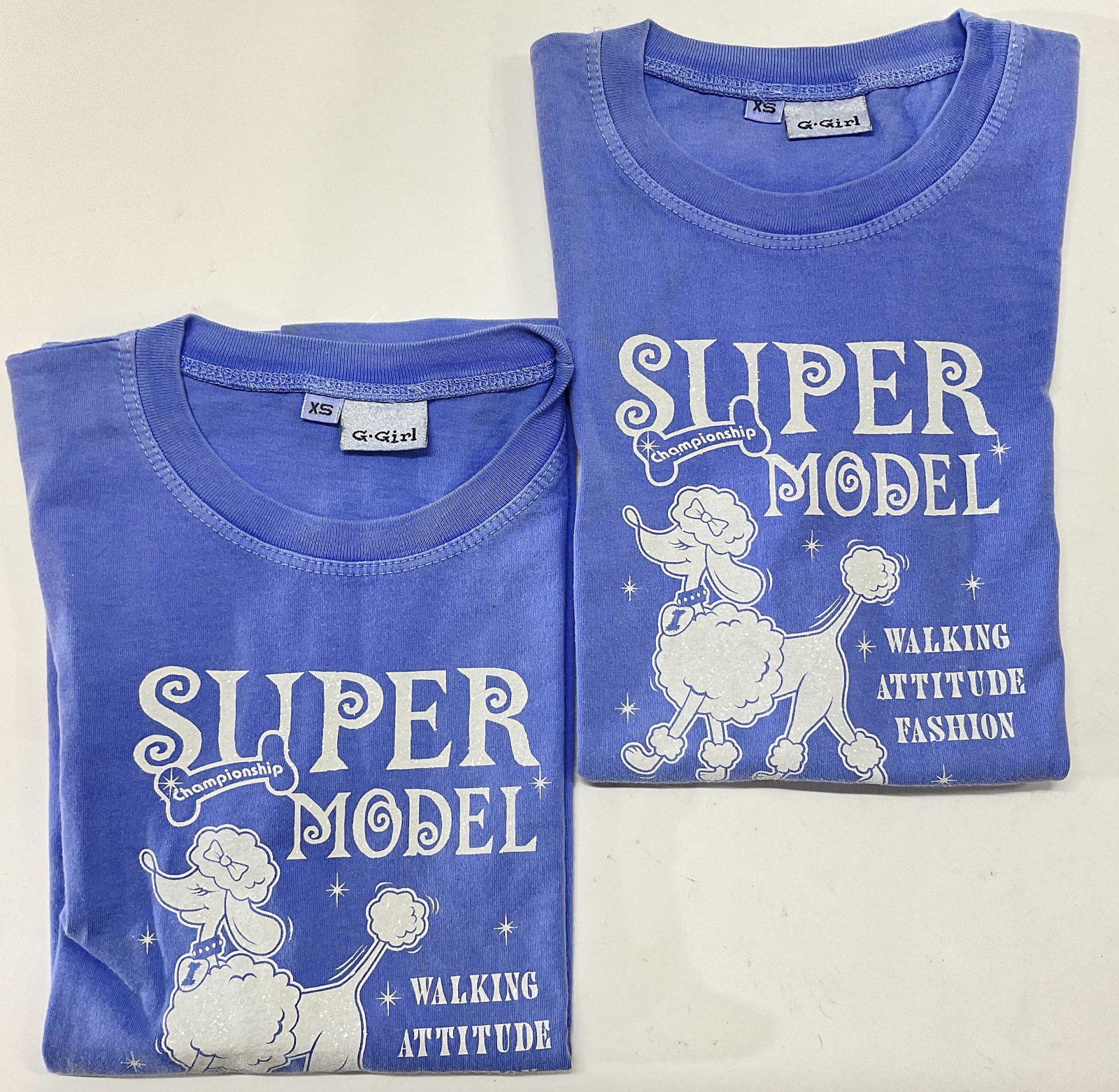 XS Vintage Super Model T-Shirts: XS Vintage Super Model T-Shirts. Shirts have sparkle detail to them with a poodle on them. Size is XS. Stain to one shirt, material tag read. 100% cotton Shirt design reads Super Model Championship Wa