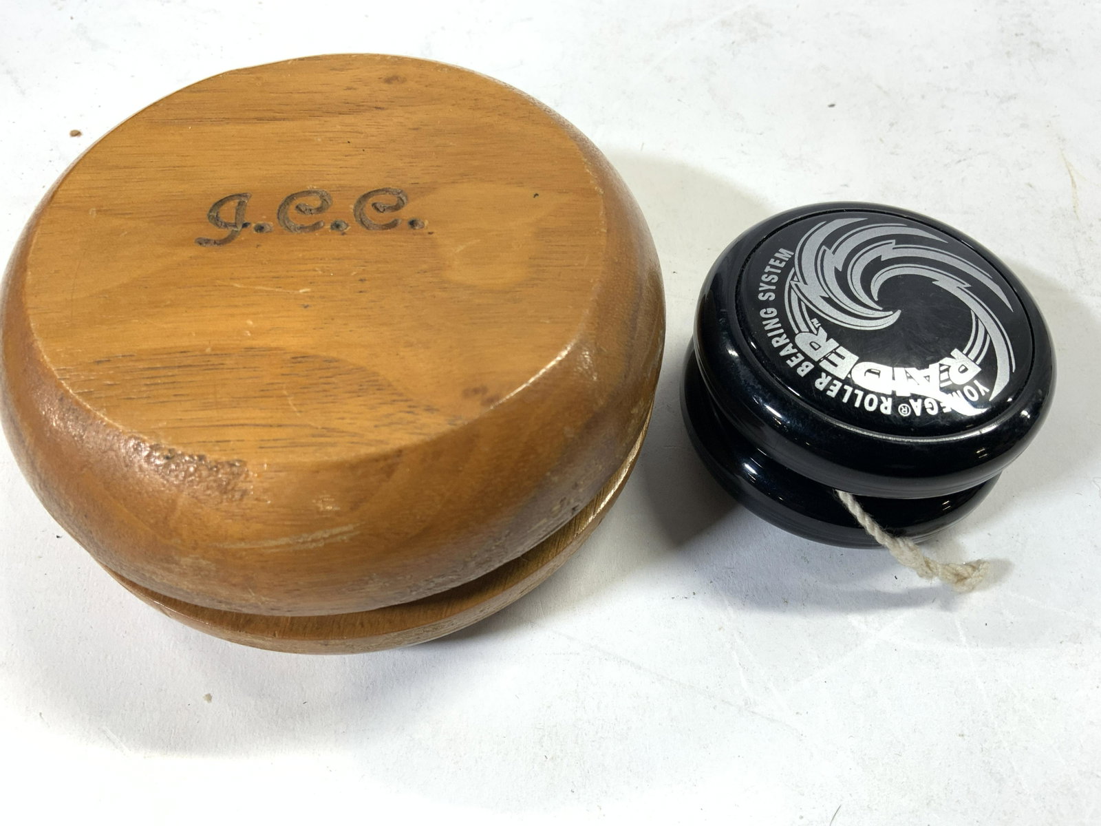 Lot 2 Vintage Yo-yos: Lot includes 2 yo-yos. One is wooden, one is plastic. Wooden yo-yo is monogrammed JCC. Plastic yo-yo read RAIDER. Largest piece measures approx 4 inches wide 2 inches deep. Yo-yo, vintage yo-yo, woode