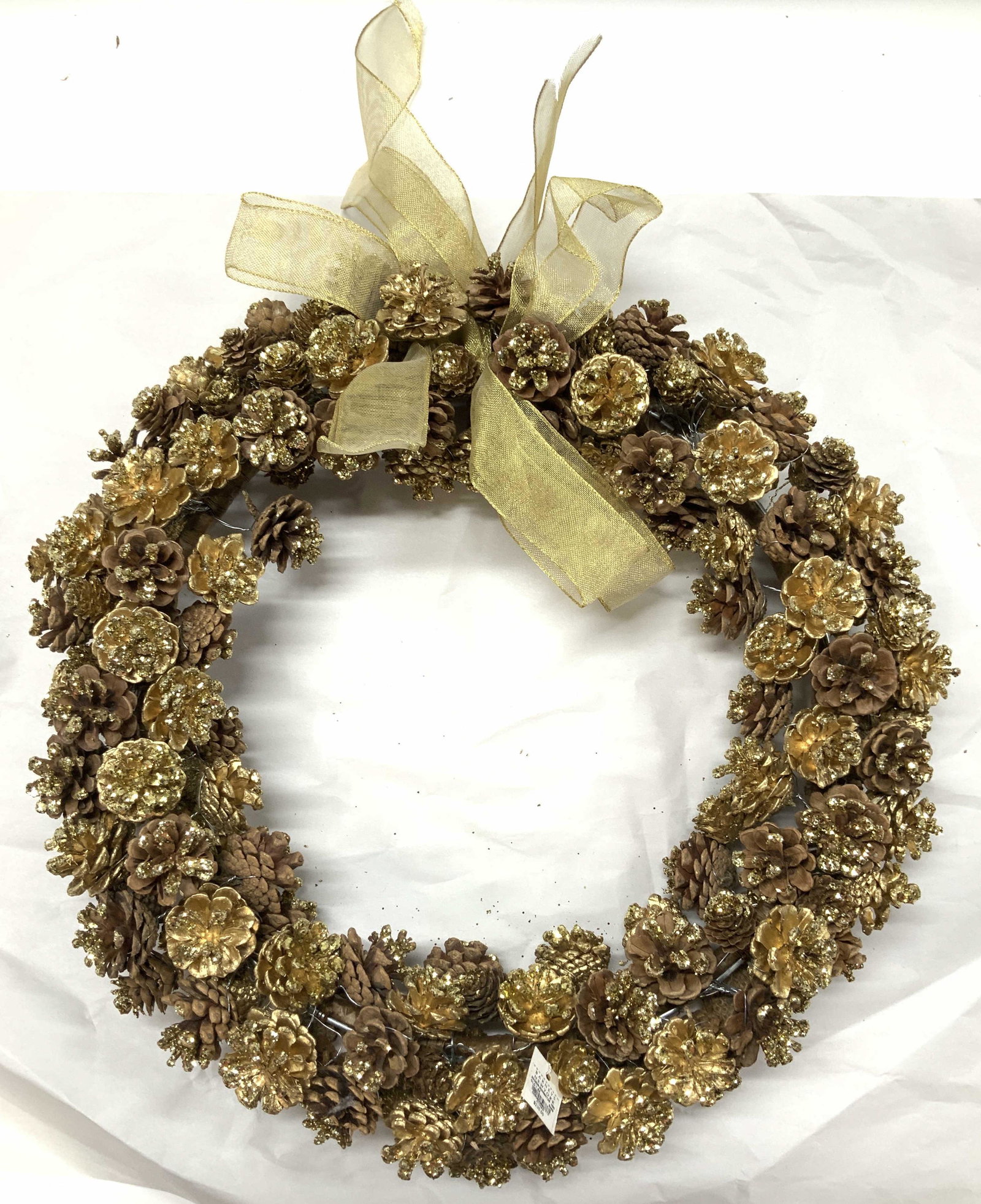 Barneys NY Handmade Glitter Pinecone Wreath: New old stock , with original tag attached is this Christmas Pinecone wreath with gold bow , spray painted gold and glitter gold Pinecones hand wired to wreath bar. 4 in deep, 18 in diameter. 3 Christ