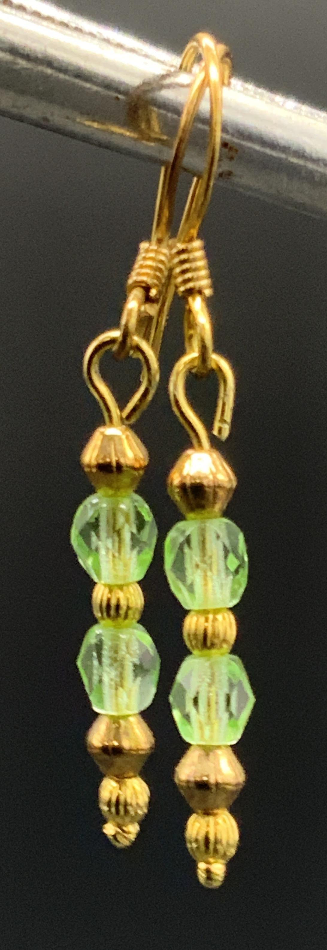 Green Crystal Drop Earrings, Minimalist Jewelry: Dainty delicate gold tone metal drop earrings featuring faceted green crystal beads & gold tone metal beads. Earrings measure approx. 1.5 inches in length. Measurement taken at earring drop length. Fi