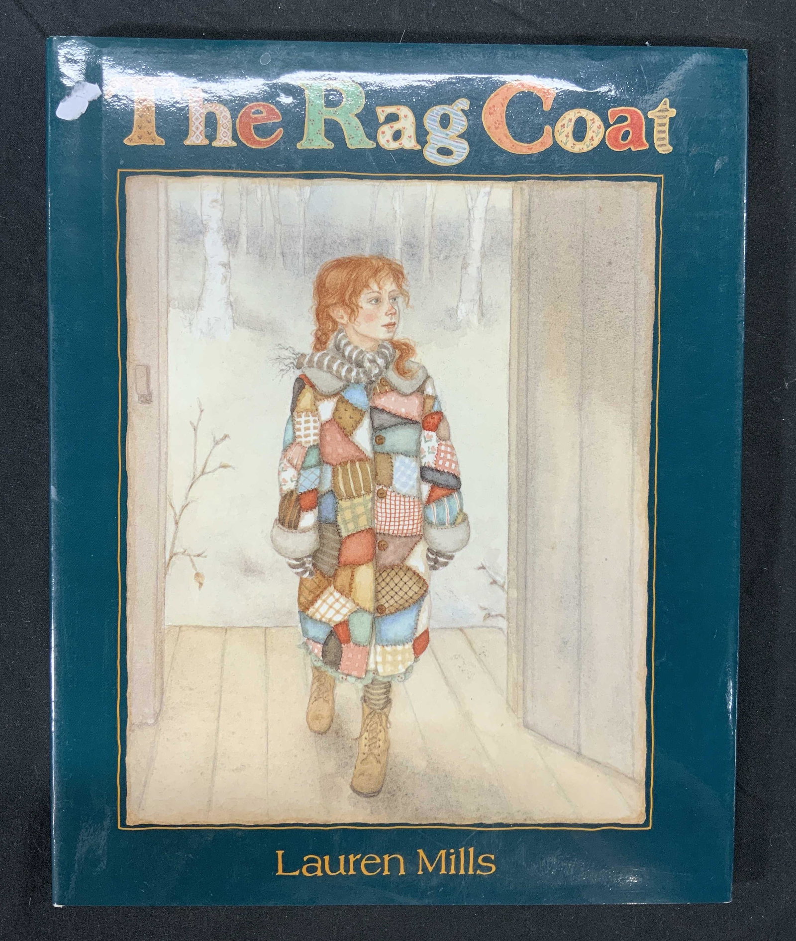 The Rag Coat by Lauren Mills First Edition: Hardcover copy of the The Rag Coat by Lauren Mills. published by Little, Brown, 1991. First edition. Some wear to book jacket consistent with exposure. The rag coat, Lauren mills, childrens book, vint