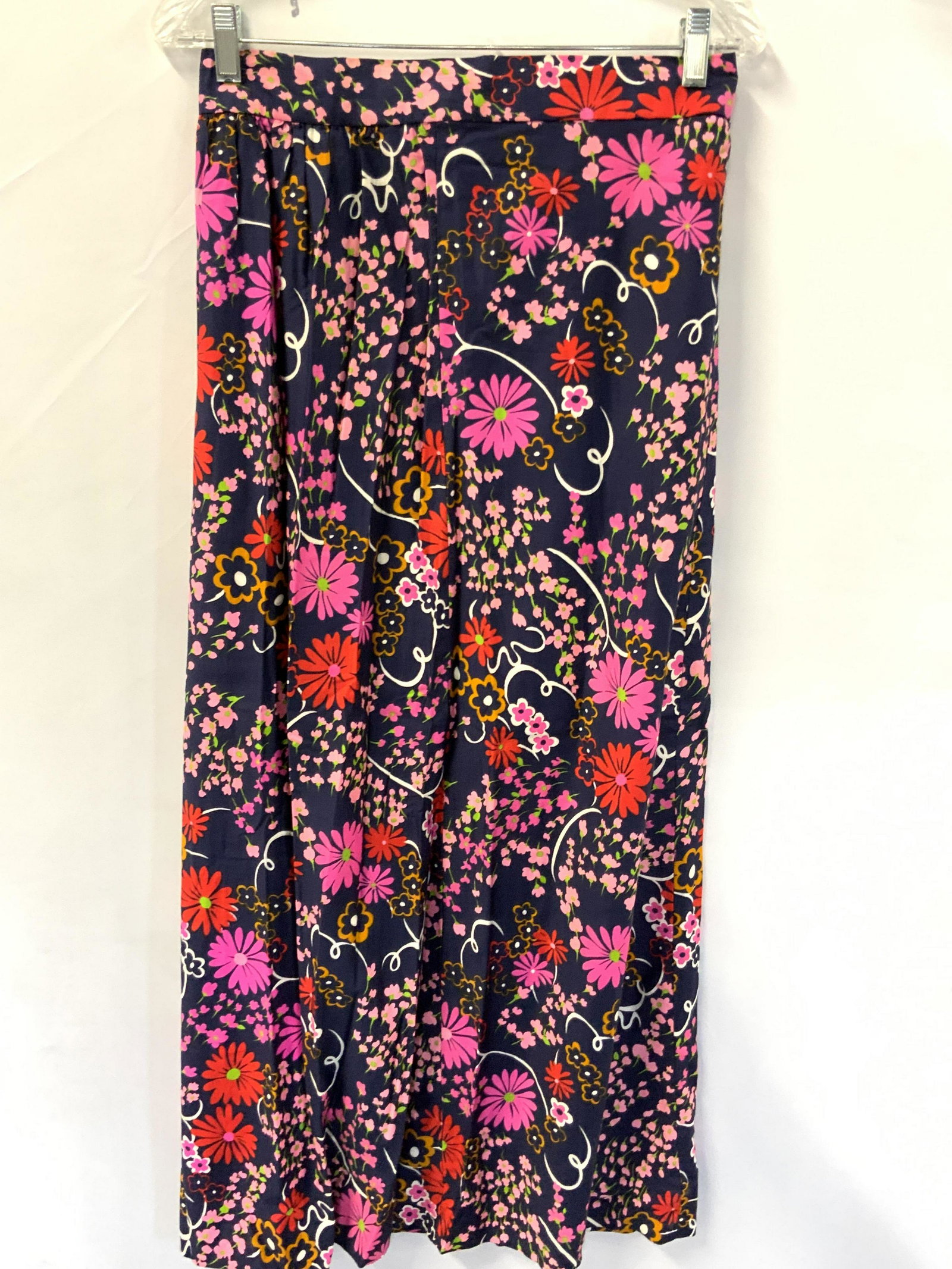 Vintage Unlabeled Floral Long Skirt: Vintage unlabeled midi skirt. Navy blue primarily with red, lime green, pink, and yellow floral pattern. Waist measures approx 28 inches, length 39 inches. No labels, possibly a linen blend. Appears t